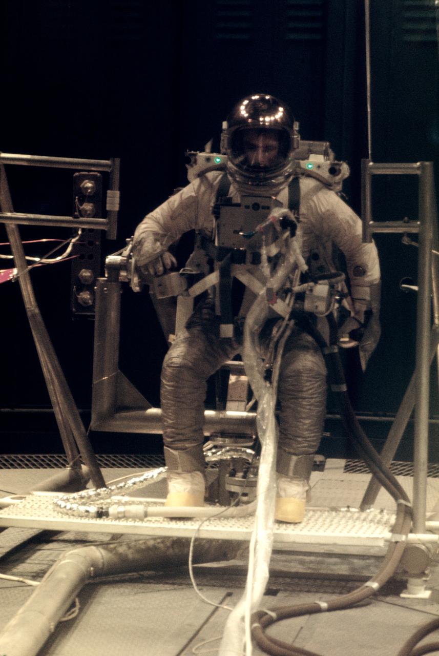 S66-27376 (19 Feb. 1966) --- Astronaut Eugene A. Cernan, pilot of the Gemini-9 spaceflight, practices with the Astronaut Maneuvering Unit during tests in Chamber B, Environmental Test Laboratory, Building 32. The AMU consists of a chest pack and a backpack. It is scheduled for use during Gemini-9 extravehicular activity (EVA). Photo credit: NASA