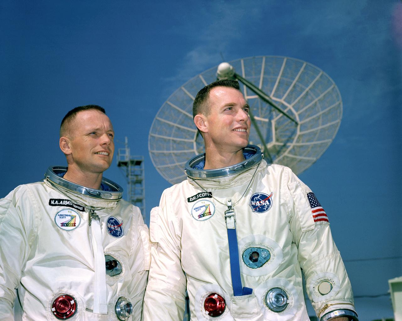 S66-27513 (11 March 1966) --- Astronauts Neil A. Armstrong (left), command pilot, and David R. Scott, pilot, the Gemini-8 prime crew, during a photo session outside the Kennedy Space Center (KSC) Mission Control Center. They are standing in front of a radar dish. Photo credit: NASA
