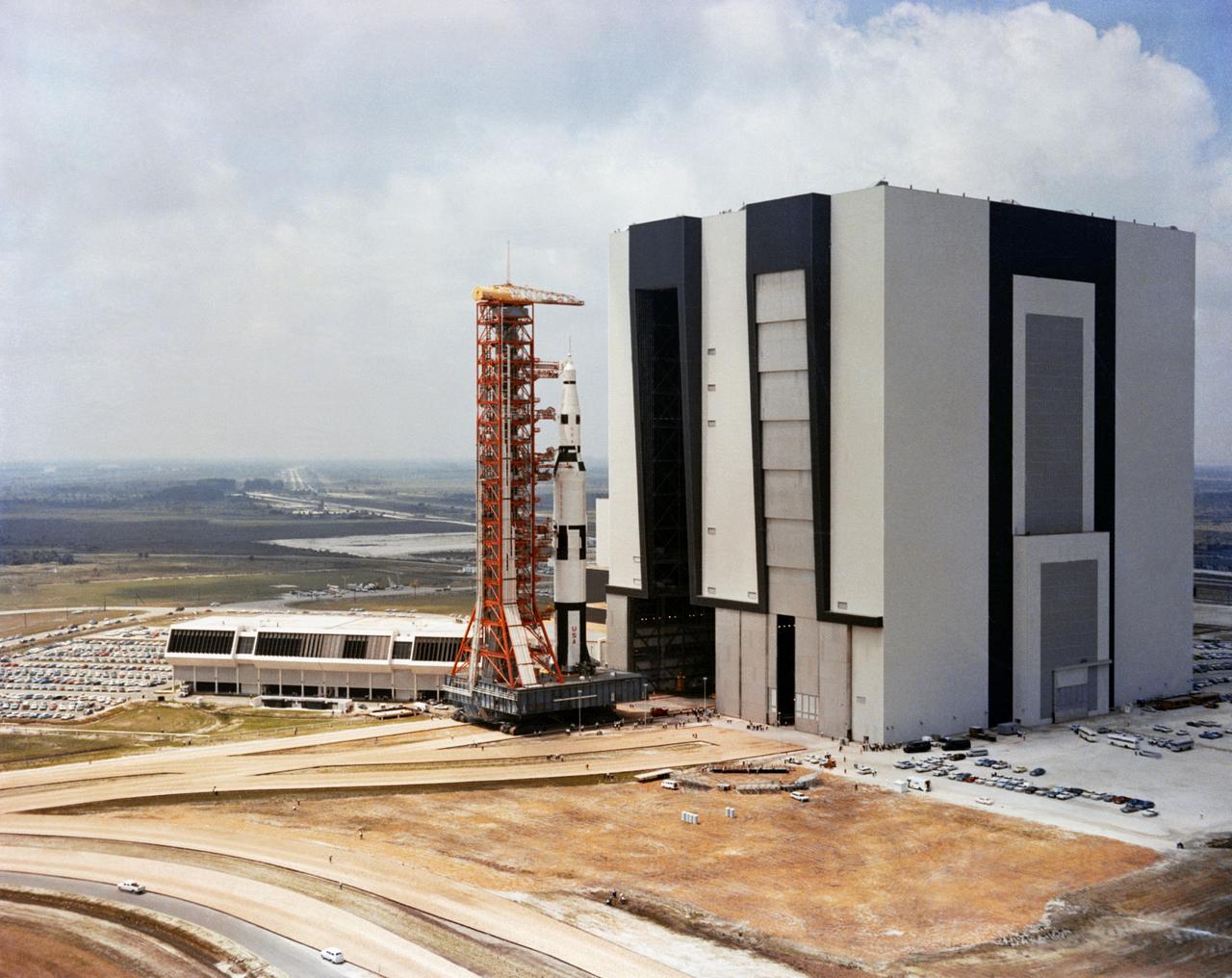 An Apollo/Saturn V facilities Test Vehicle and Launch Umbilical Tower (LUT) atop a crawler-transporter move from the Vehicle Assembly Building (VAB) on the way to Pad A. This test vehicle, designated the Apollo/Saturn 500-F, is being used to verify launch facilities, train launch crews, and develop test and checkout procedures.
