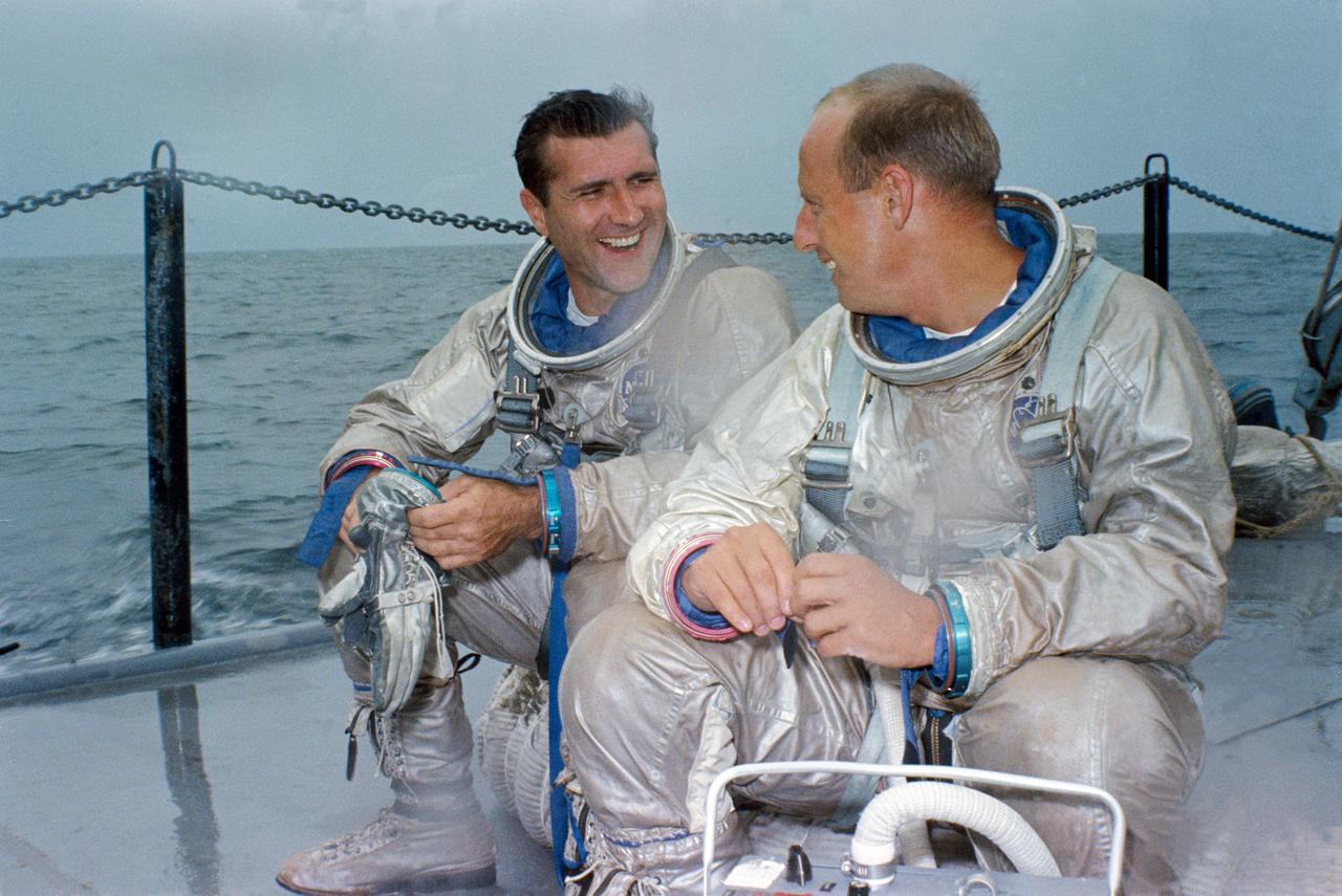 S66-44511 (13 July 1966) --- The Gemini-11 prime crew, astronauts Richard F. Gordon Jr. (left), pilot, and Charles Conrad Jr., command pilot, relax on deck of the NASA Motor Vessel Retriever after suiting up for water egress training in the Gulf of Mexico. Photo credit: NASA