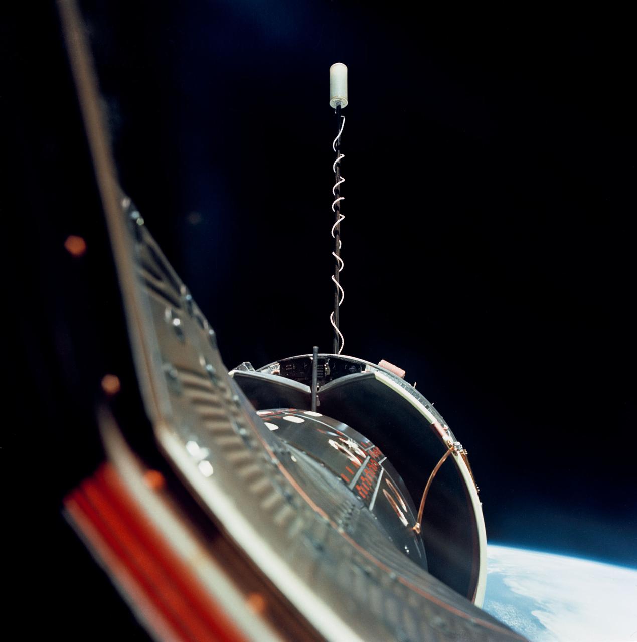 S66-46144 (18 July 1966) --- The Gemini-10 spacecraft is successfully docked with the Agena Target Docking Vehicle 5005. The Agena display panel is clearly visible. After docking with the Agena, astronauts John W. Young, command pilot, and Michael Collins, pilot, fired the 16,000-pound thrust engine of Agena-10's primary propulsion system to boost the combined vehicles into an orbit with an apogee of 413 nautical miles to set a new altitude record for manned spaceflight. Photo credit: NASA