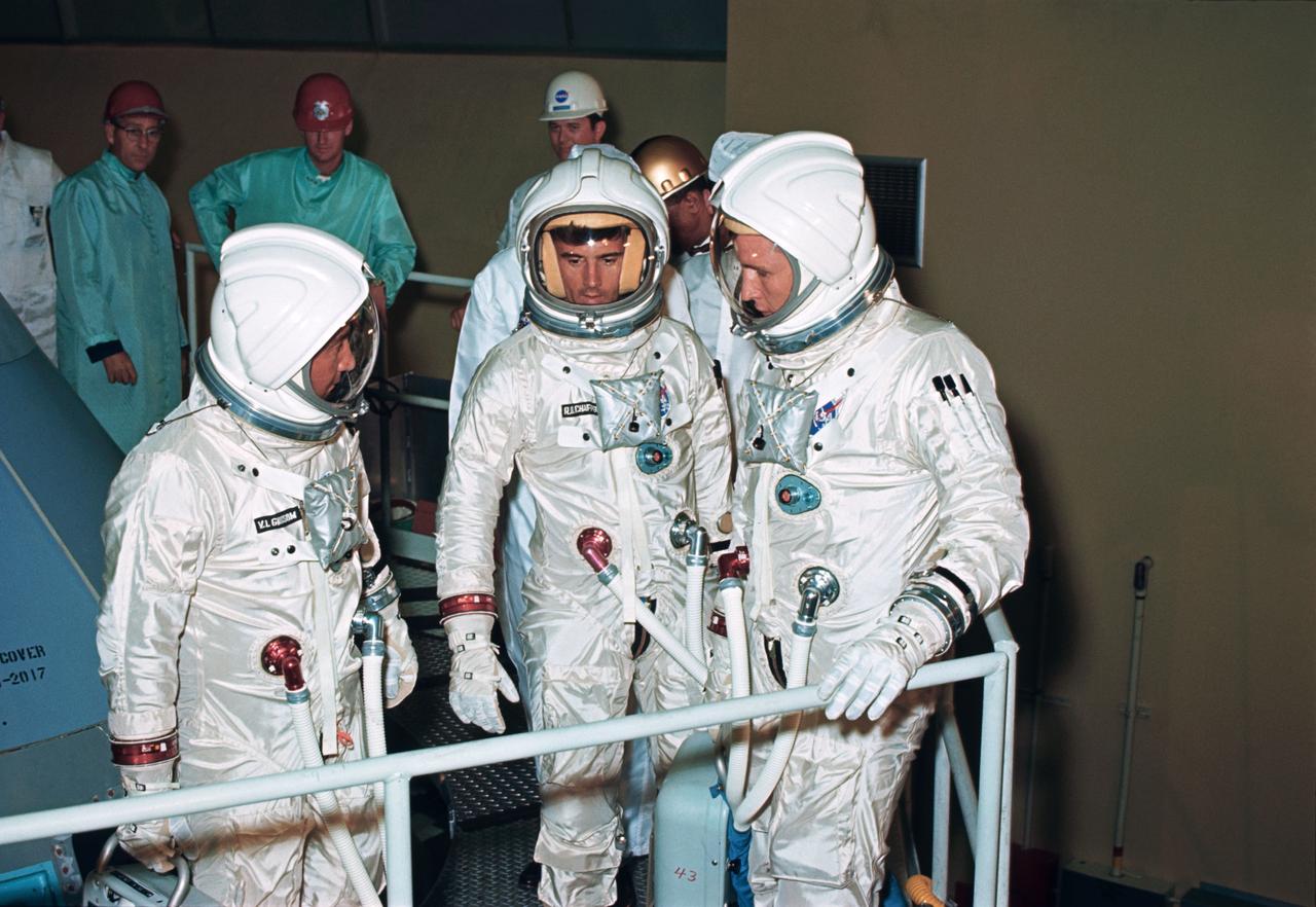 S66-49181 (August 1966) --- The three crew members for the Apollo-Saturn 204 (AS-204) mission check out the couch installation on the Apollo Command Module (CM) at North American's Downey facility. Left to right in their pressurized space suits are astronauts Virgil I. Grissom, Roger B. Chaffee and Edward H. White II.     Editor's Note: The three astronauts died in a fire on the launch pad, Jan. 27, 1967.