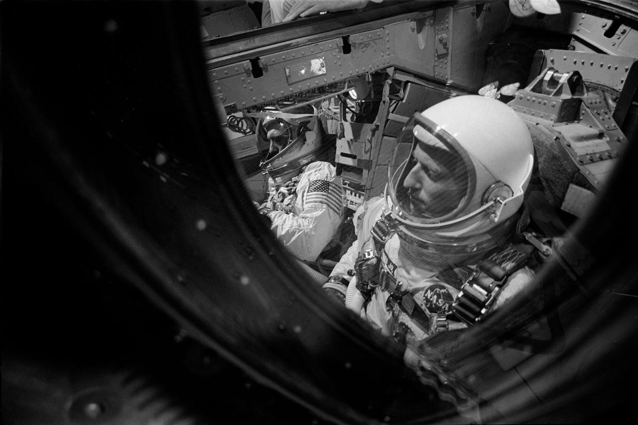 S66-50714 (12 Sept. 1966) --- Astronauts Charles Conrad Jr. (foreground), command pilot, and Richard F. Gordon Jr., pilot, are seen in the Gemini-11 spacecraft in the white room atop Pad 19 awaiting the final minutes of the prelaunch countdown. The Gemini-11 liftoff was at 9:42 a.m. (EST), Sept. 12, 1966. Photo credit: NASA