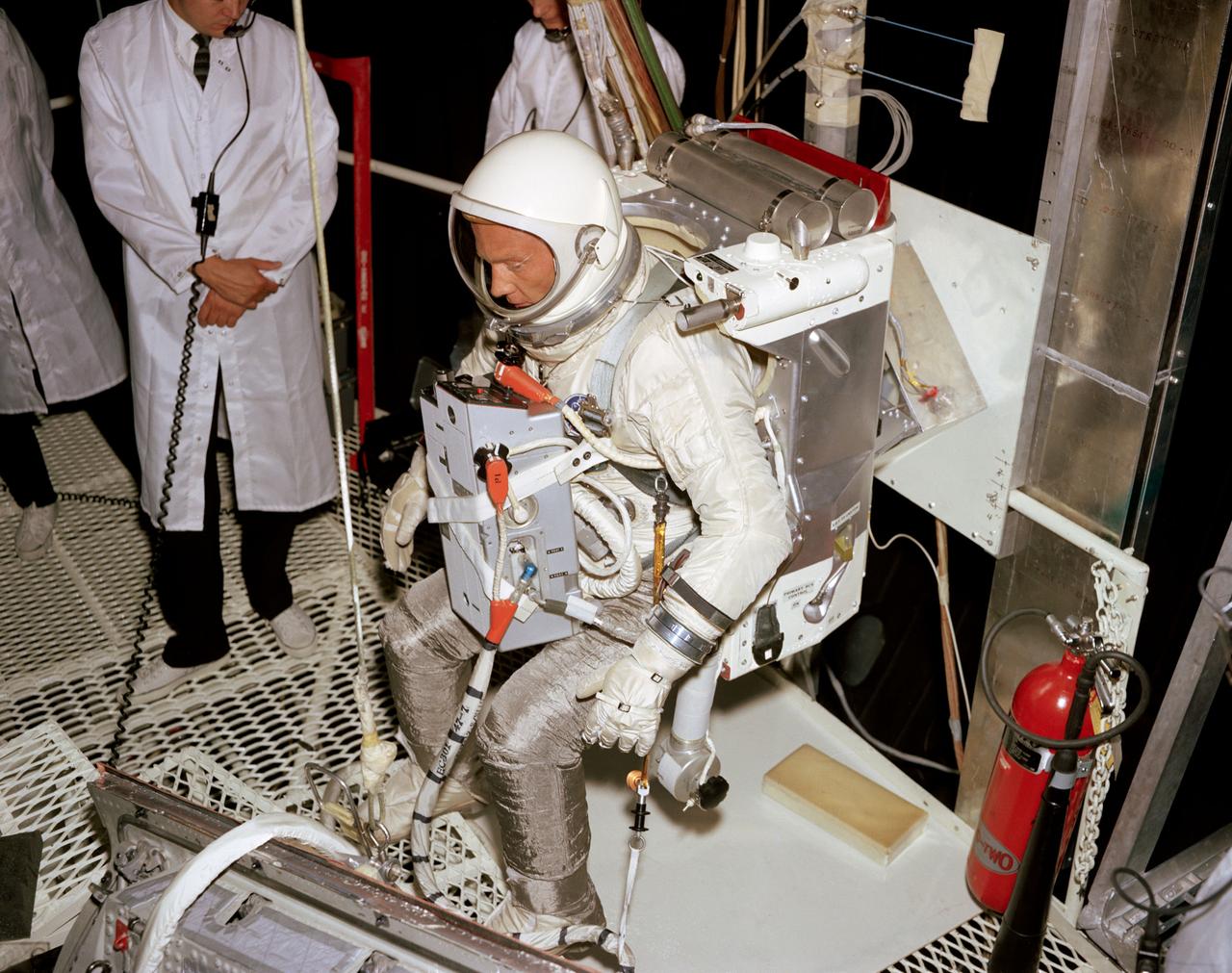 S66-51073 (15 Aug. 1966) --- Astronaut Edwin E. Aldrin Jr., prime crew pilot of the Gemini-12 spaceflight, undergoes evaluation procedures with the Astronaut Maneuvering Unit in the 30-foot altitude chamber at McDonnell. The suited Aldrin is wearing an AMU backpack and an Extravehicular Life Support System (ELSS) chest pack. Photo credit: NASA