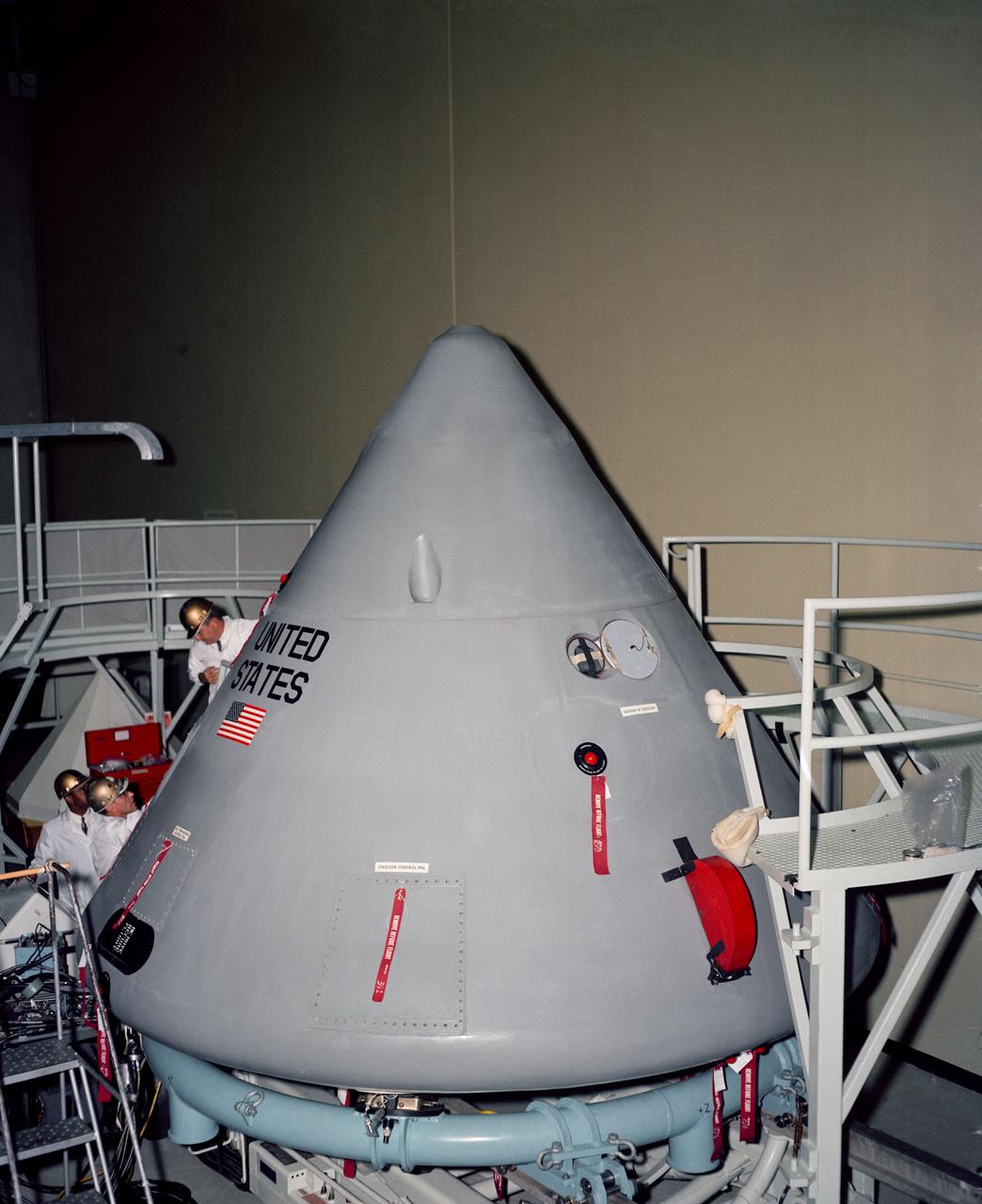 S66-53655 (1966) --- High angle view of Apollo Spacecraft 012 Command Module looking toward +Z axis during pre-shipping operations in south air lock of Systems Integration and Checkout Facility.