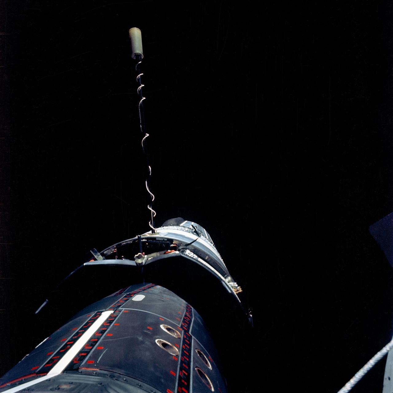 S66-54555 (14 Sept. 1966) --- The Gemini-11 spacecraft is docked to the Agena Target Vehicle in this photograph taken by astronaut Richard F. Gordon Jr., pilot, as he stood in the open hatch of the Gemini-11 spacecraft during his extravehicular activity (EVA). Note Agena's L-band antenna. Taken during Gemini-11's 29th revolution of Earth, using a modified 70mm Hasselblad camera, with Eastman Kodak, Ektachrome, MS (S.O. 368) color film. Photo credit: NASA