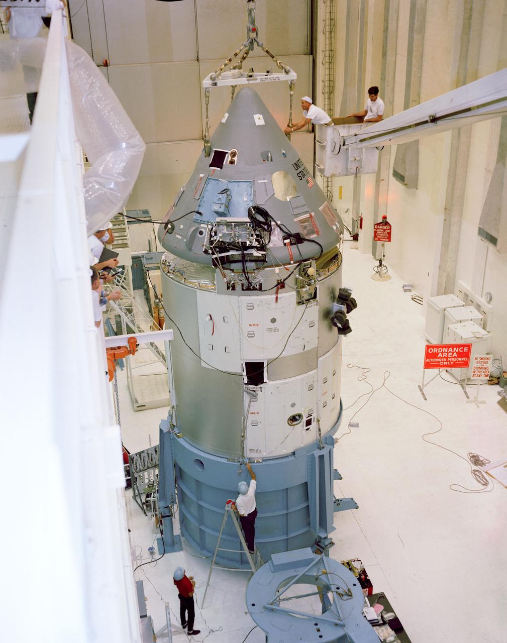 S67-15717 (1967) --- Apollo Spacecraft 012 Command/Service Module is moved from H-134 to east stokes for mating to the Saturn Lunar Module Adapter No. 05 in the Manned Spacecraft Operations Building. S/C 012 will be flown on the Apollo/Saturn 204 mission.