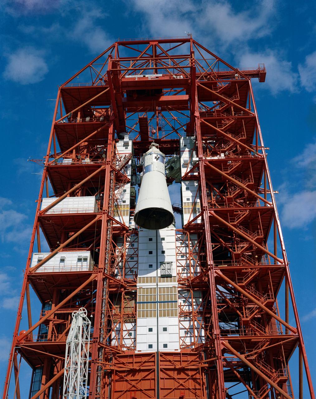 S67-15885 (1967) --- Apollo Spacecraft 012 is hoisted to the top of the gantry at Pad 34 during the Apollo/Saturn Mission 204 erection.