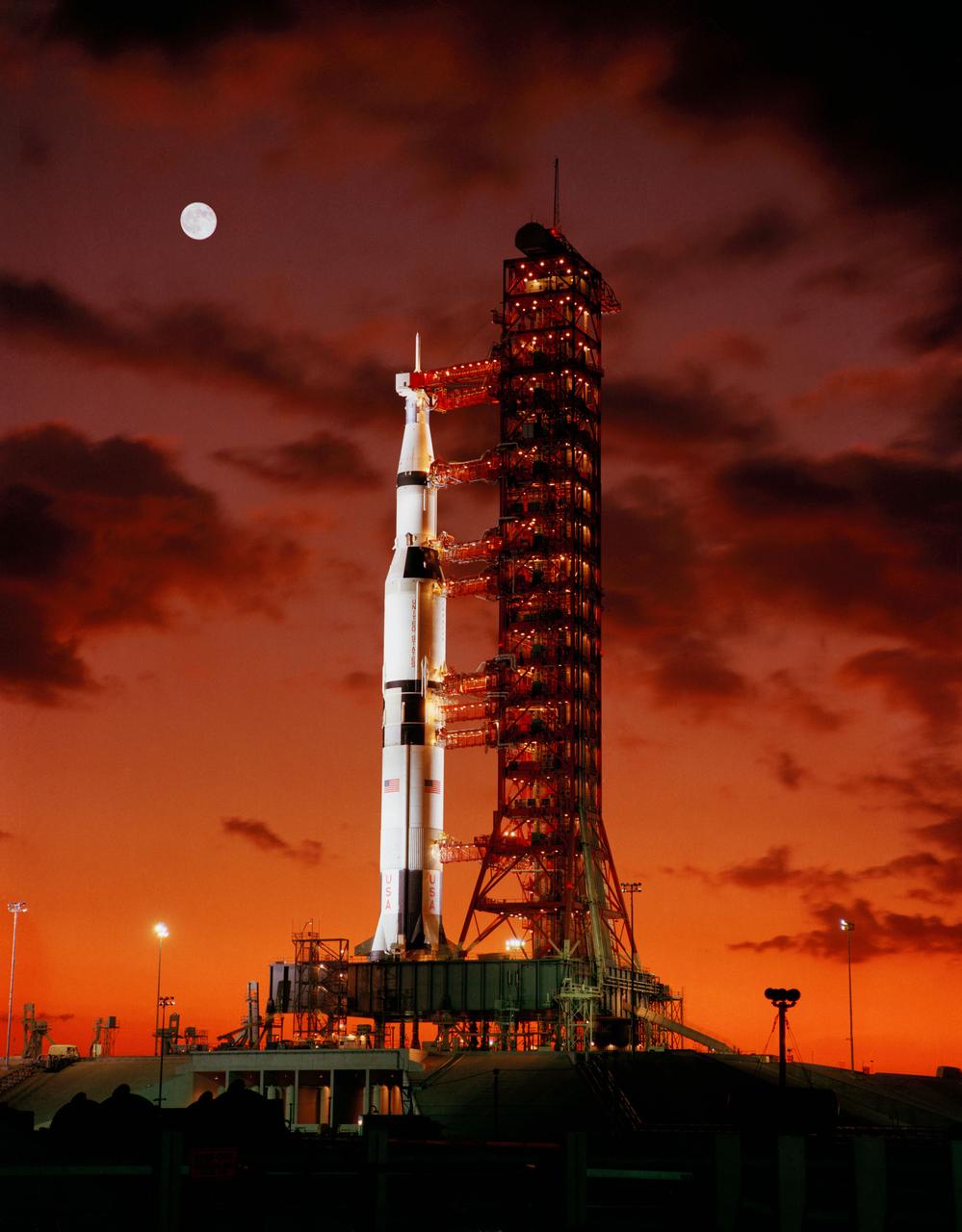 Early morning view of Pad A, Launch Complex 39, Kennedy Space Center, showing Apollo 4 (Spacecraft 017/Saturn 501) unmanned, earth-orbital space mission ready for launch, with a full moon in the upper left part of the image. The 363-foot tall Apollo/Saturn V space vehicle was launched at 7:00:01 AM (EST), November 9, 1967.