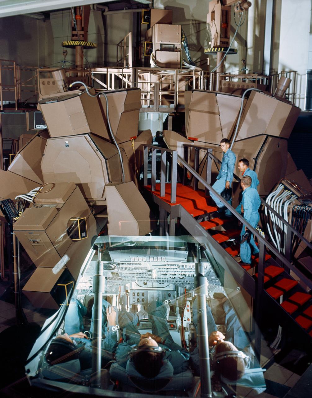 S67-50585 (1967) --- This is an intentional double exposure showing the Apollo Mission Simulator in the Mission Simulation and Training Facility, Building 5 at the Manned Spacecraft Center. In the exterior view astronauts William A. Anders, Michael Collins, and Frank Borman (reading from top of stairs) are about to enter the simulator. The interior view shows the three astronauts in the simulator. They are (left to right) Borman, Collins, and Anders. Photo credit: NASA
