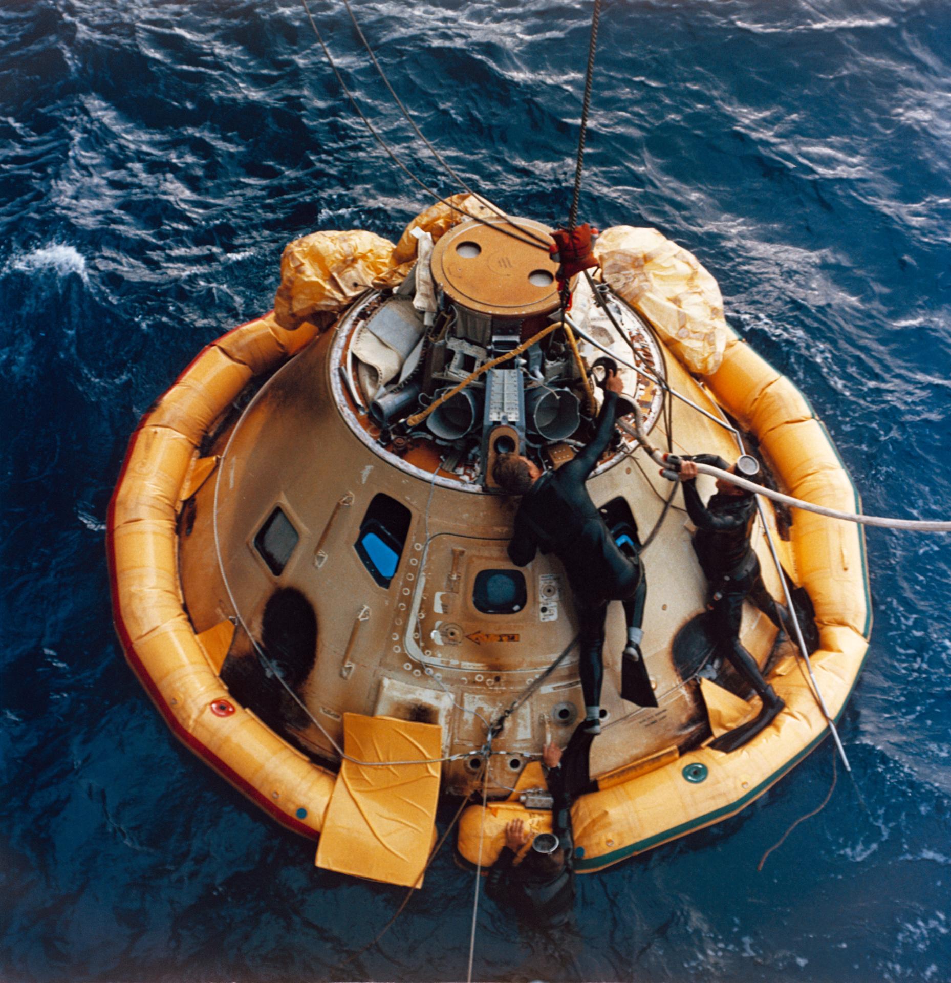View of the uncrewed Apollo 6 command module floating in the Pacific Ocean after flight.