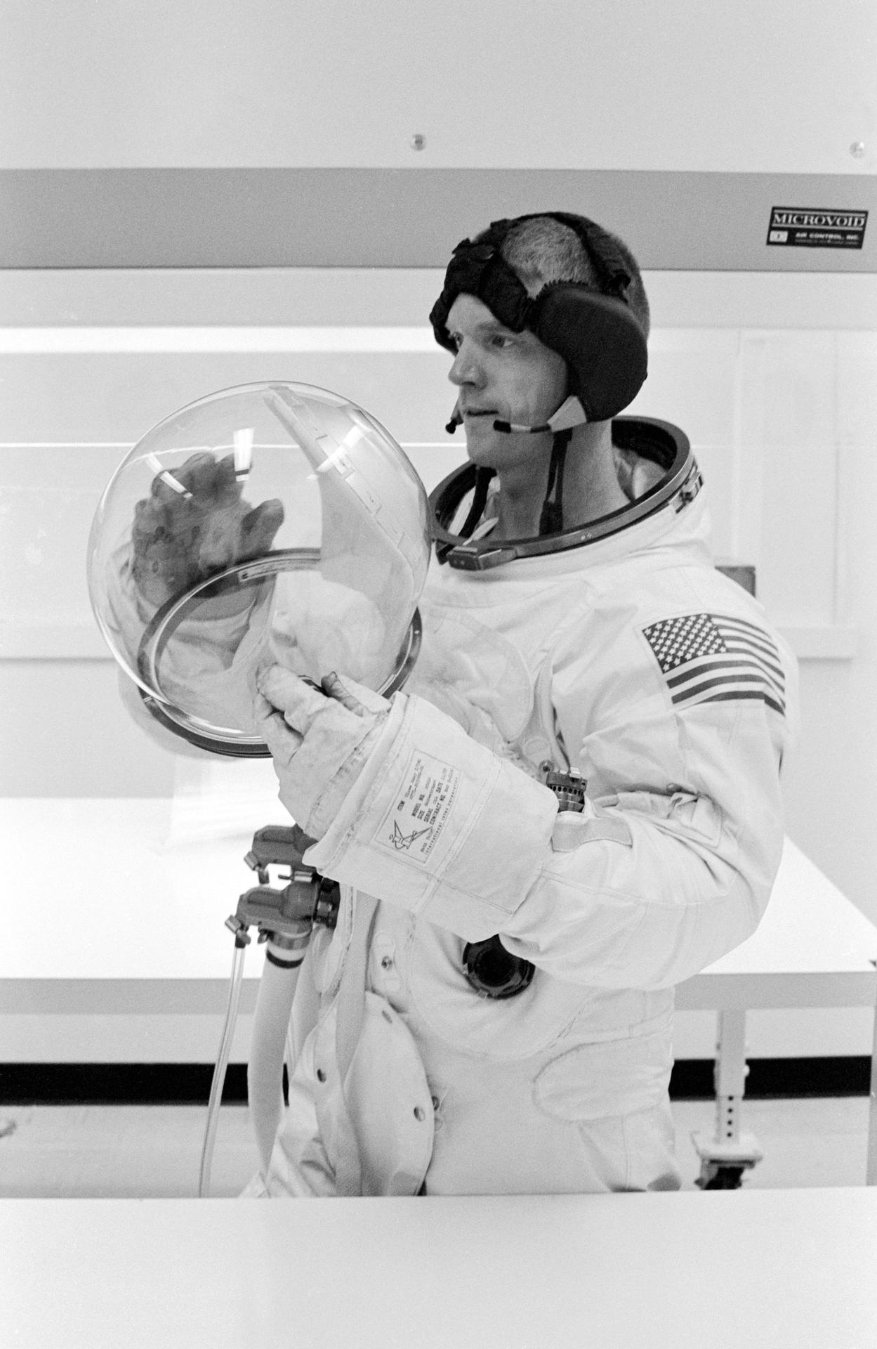 Portrait of Rusty Schweickart suiting up during a test of the Apollo PLSS