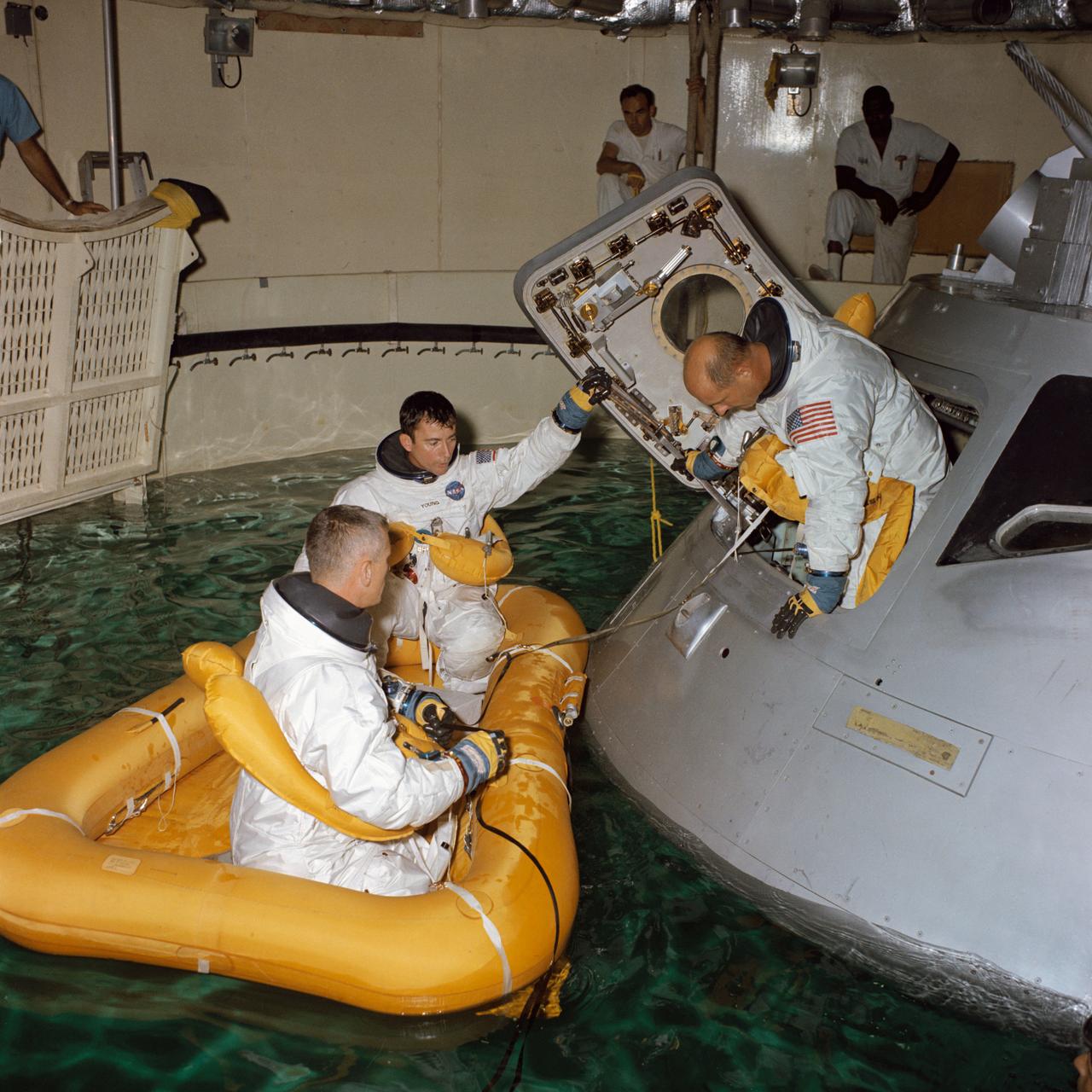 S68-41685 (August 1968) --- Three astronauts participate in Apollo water egress training in a tank in Building 260 at the Manned Spacecraft Center. Egressing the Apollo Command Module trainer is Thomas P. Stafford. Already in life raft are Eugene A. Cernan (in foreground) and John W. Young.