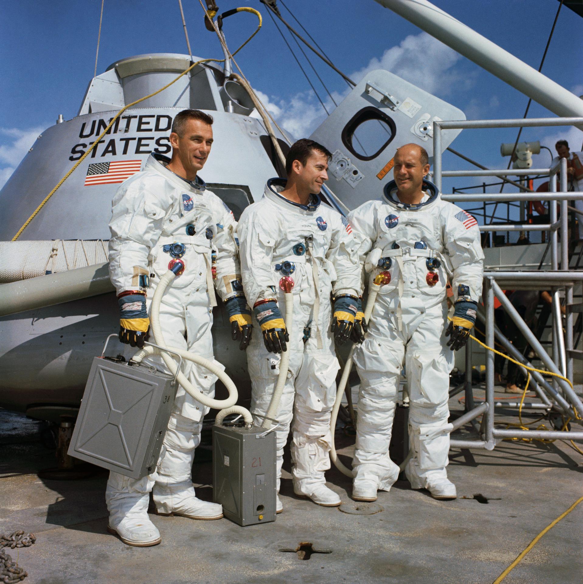 The Apollo 10 prime crew poses in their space suits in front of an Apollo command module