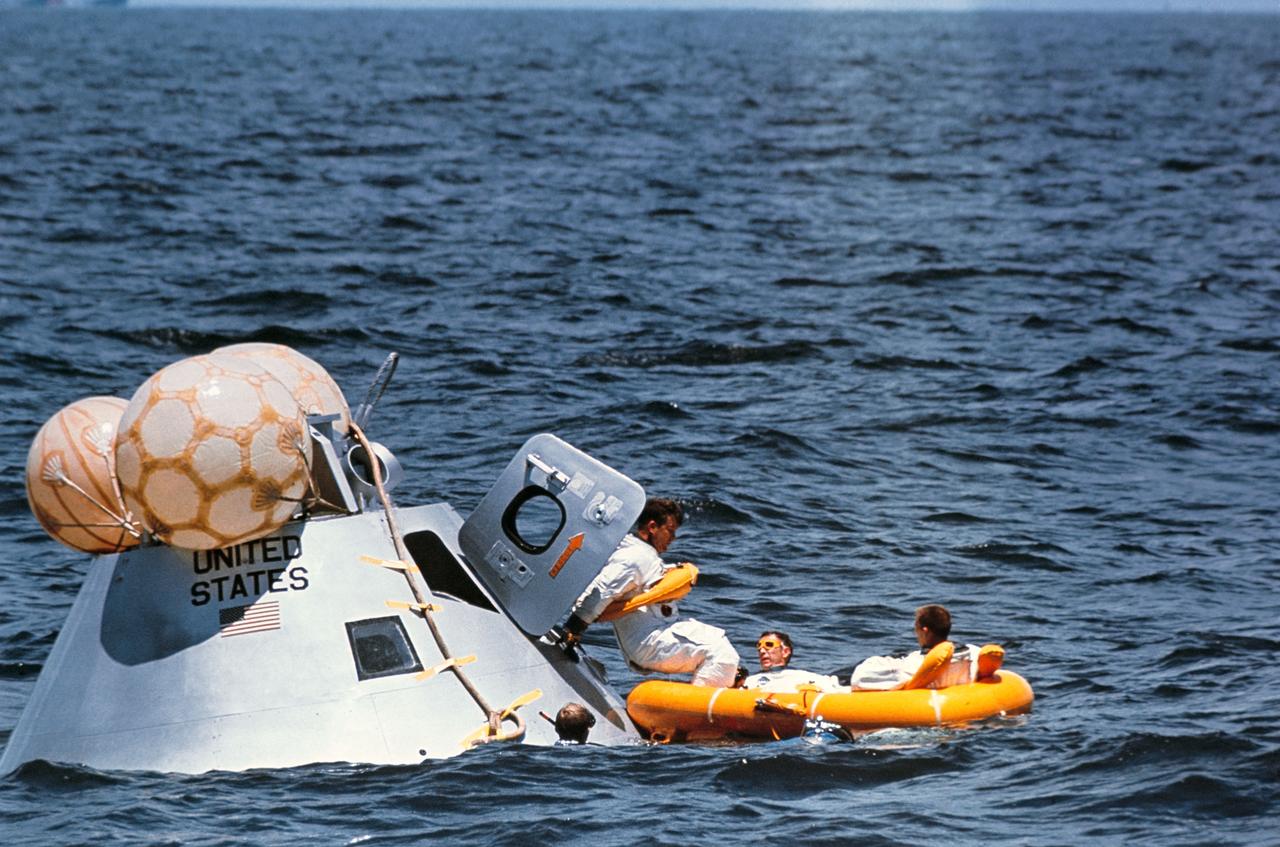 S68-46605 (5 Aug. 1968) --- The prime crew of the first manned Apollo mission (Spacecraft 101/Saturn 205) participates in water egress training in the Gulf of Mexico. Left to right, are astronauts Walter M. Schirra Jr. (stepping into life raft), Donn F. Eisele, and Walter Cunningham. They have just egressed Apollo Command Module Boilerplate 1102, and are awaiting helicopter pickup. Inflated bags were used to upright the boilerplate. MSC swimmers assisted in the training exercise.