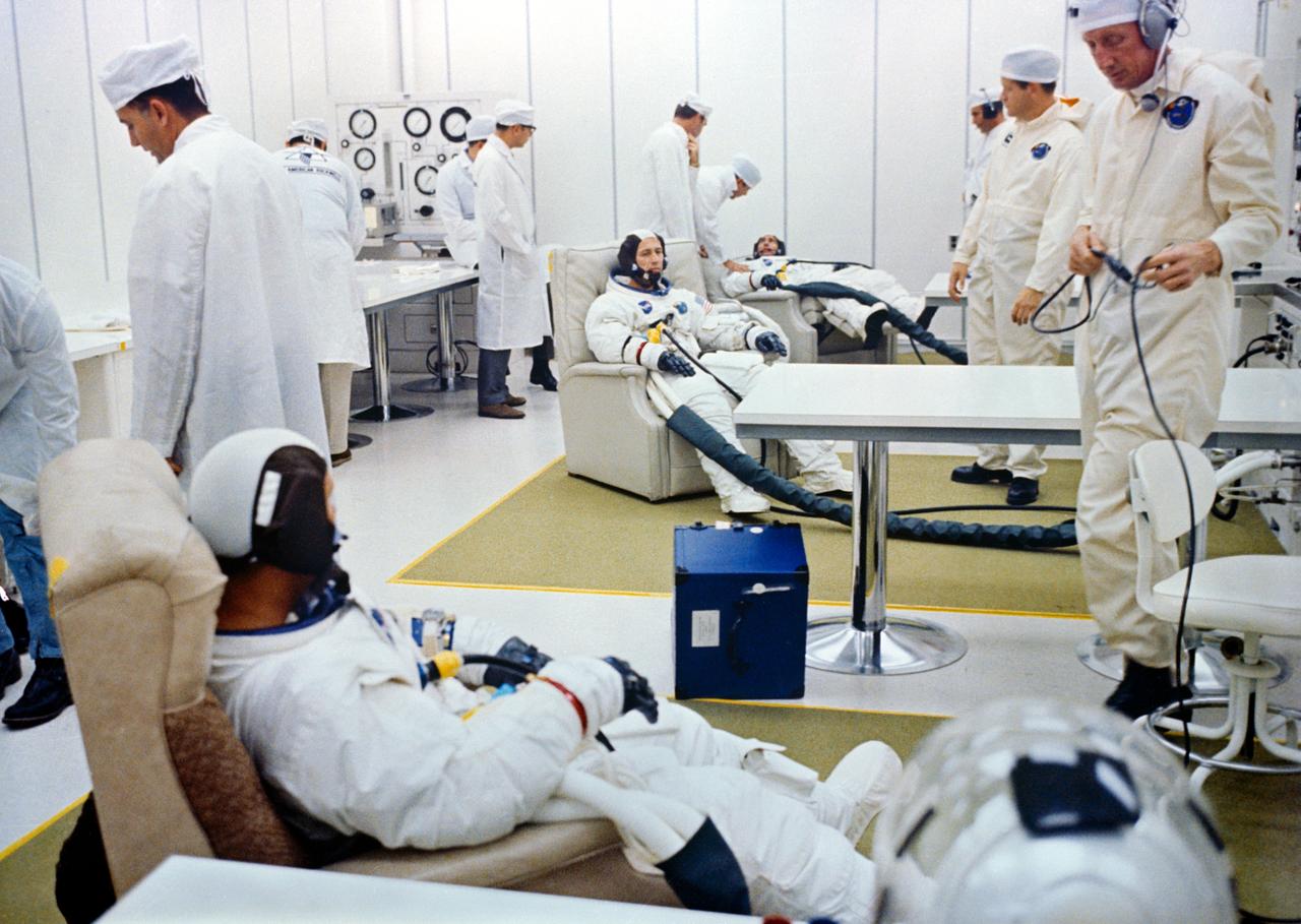 The Apollo 7 prime crew goes through suiting up operations in the Kennedy Space Center's Manned Spacecraft Operations Building during the Apollo 7 prelaunch countdown. From front to rear, are Astronauts Walter M. Schirra Jr., commander; Donn F. Eisele, command module pilot; and Walter Cunningham, lunar module pilot.