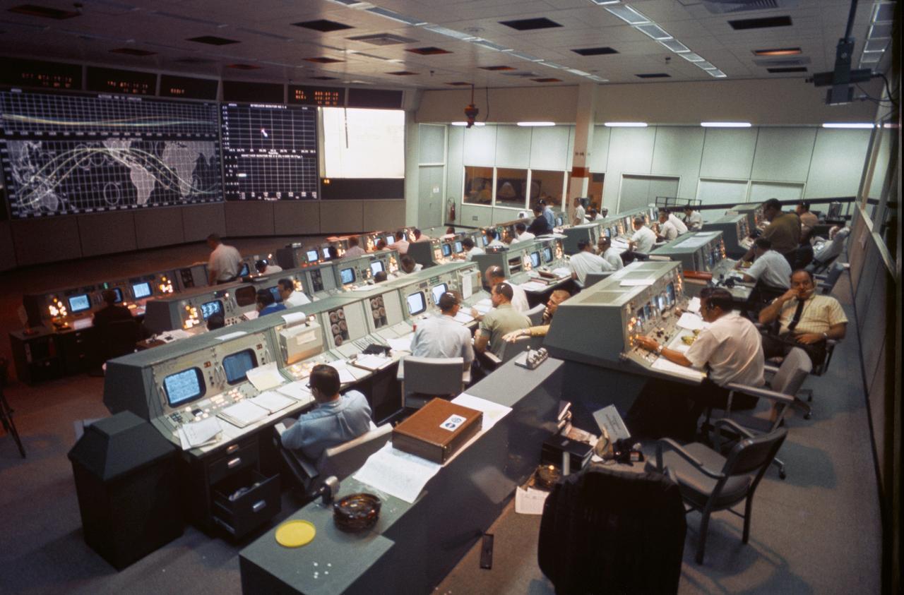 Overall view of activity in the Mission Operations Control Room in the Mission Control Center, Bldg 30, on the first day of the Apollo 7 space mission.