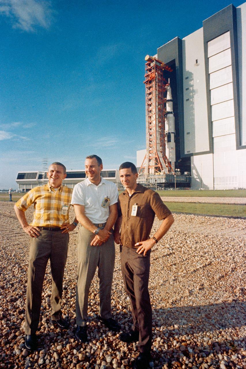 S68-49397 (9 Oct. 1968) --- The Apollo 8 prime crew stands in foreground as the Apollo (Spacecraft 103/Saturn 503) space vehicle leaves the Kennedy Space Center's Vehicle Assembly Building on way to Pad A, Launch Complex 39. The Saturn V stack and its mobile launch tower are atop a huge crawler-transporter. The Apollo 8 crew consists of (left to right) astronauts Frank Borman, commander; James A. Lovell Jr., command module pilot; and William A. Anders, lunar module pilot.
