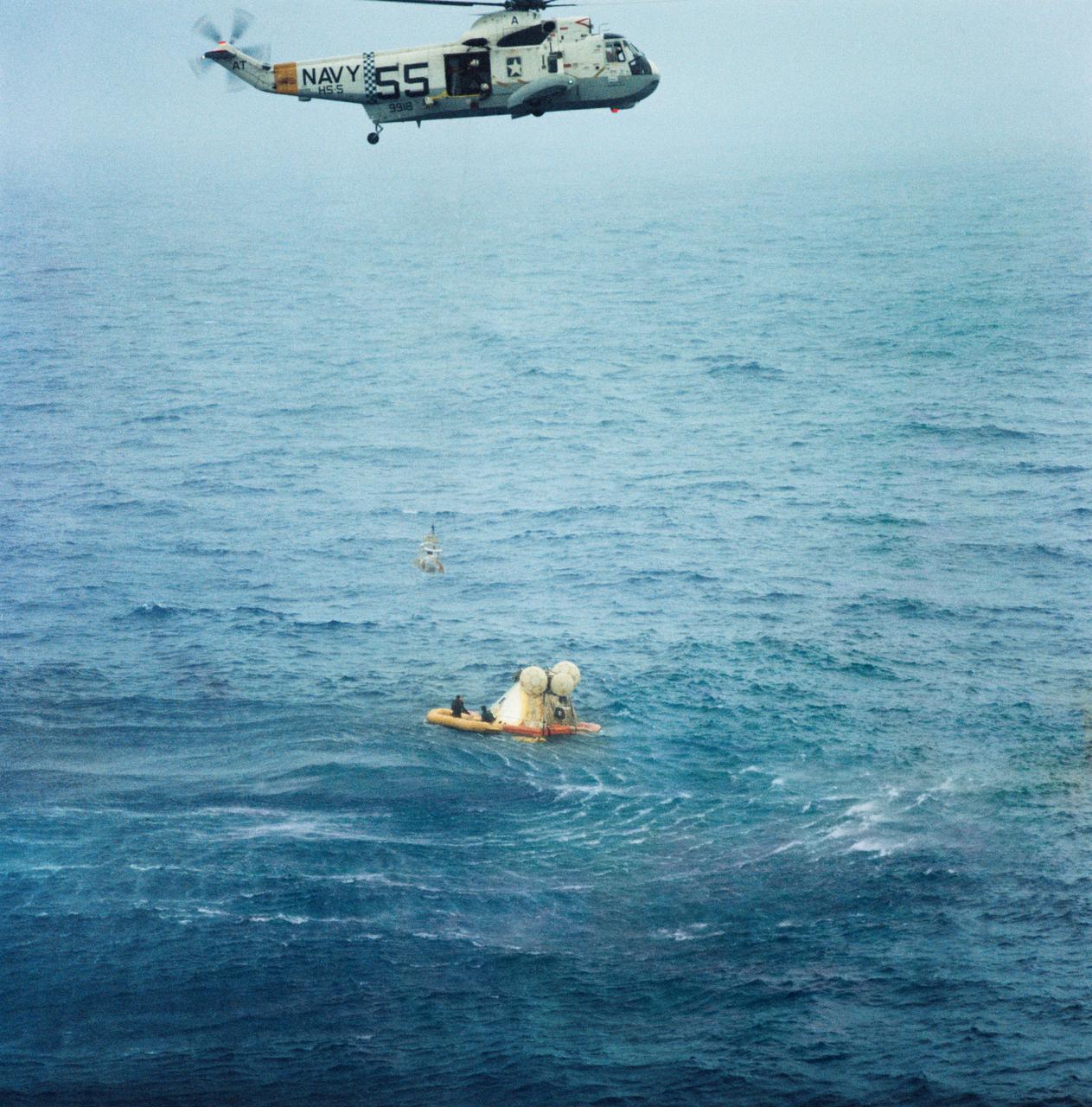 S68-49661 (22 Oct. 1968) --- A member of the Apollo 7 crew is hoisted up to a recovery helicopter from the USS Essex during recovery operations. The Apollo 7 spacecraft splashed down at 7:11 a.m., Oct. 22, 1968, approximately 200 nautical miles south-southwest of Bermuda. Photo credit: NASA