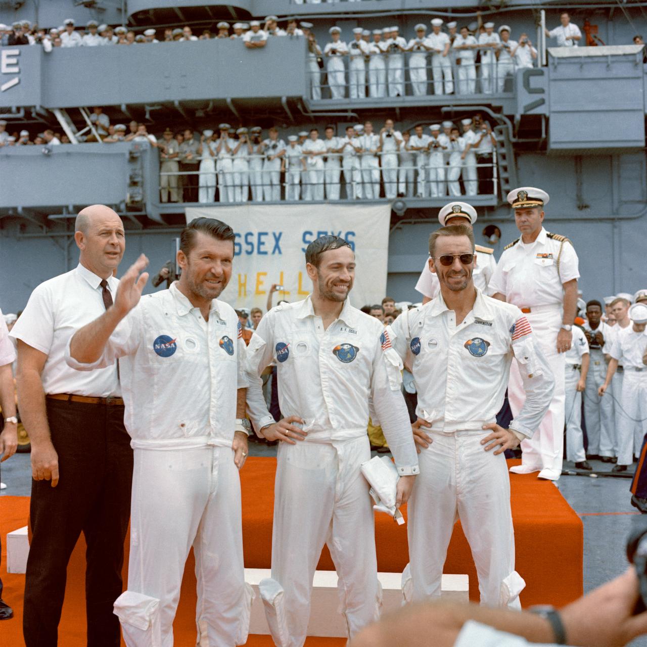 S68-49744 (22 Oct. 1968) --- The Apollo 7 crew is welcomed aboard the USS Essex, the prime recovery ship for the mission. Left to right, are astronauts Walter M. Schirra Jr., commander; Donn F. Eisele, command module pilot; and Walter Cunningham, lunar module pilot. In left background is Dr. Donald E. Stullken, NASA Recovery Team Leader from the Manned Spacecraft Center's (MSC) Landing and Recovery Division.