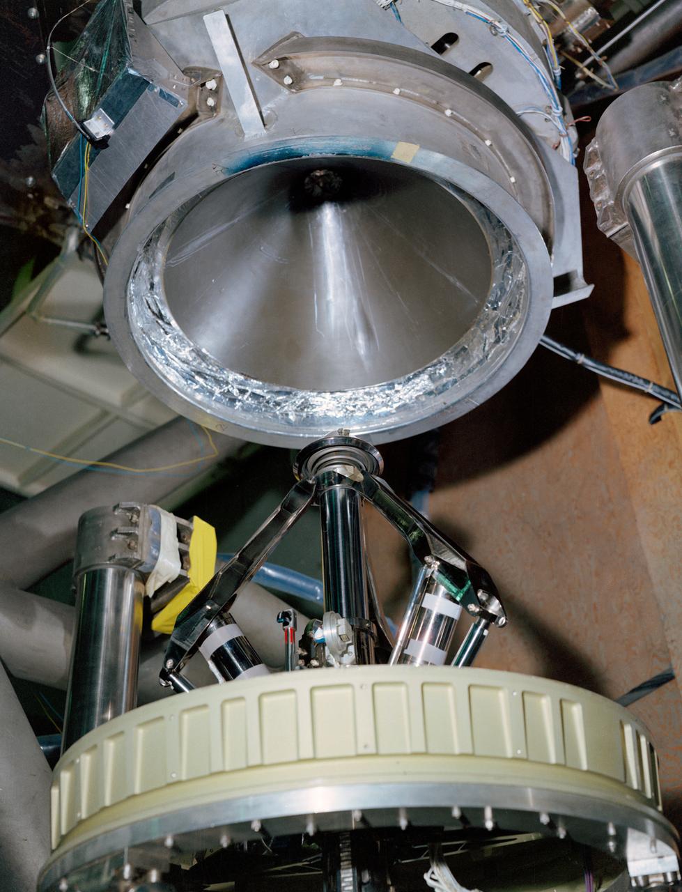 S68-50869 (1968) --- An engineering set up illustrating the docking system of the Apollo spacecraft. During docking maneuvers the docking probe on the Command Module engages the cone-shaped drogue of the Lunar Module. The primary docking structure is the tunnel through which the astronauts transfer from one module to the other. This tunnel is partly in the nose of the Command Module and partly in the top of the Lunar Module. Following CSM/LM docking the drogue and probe are removed to open the passageway between the modules.