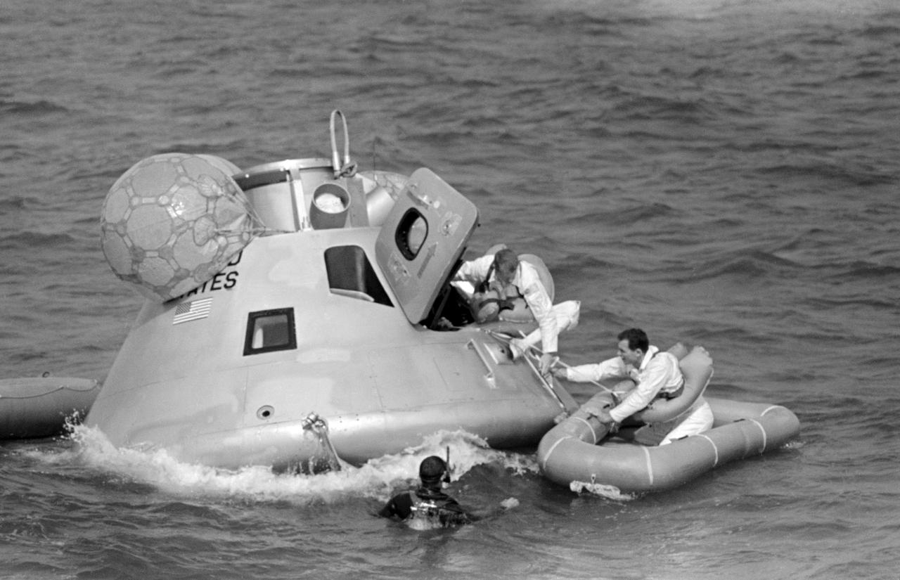 S68-50960 (20 Nov. 1968) --- The Apollo 9 prime crew participates in water egress training in the Gulf of Mexico. Apollo Command Module Boilerplate 1102 was used in the training. In life raft is astronaut David R. Scott, command module pilot. Egressing the boilerplate is astronaut Russell L. Schweickart, lunar module pilot. Still inside boilerplate, out of view, is astronaut James A. McDivitt, commander. A team of MSC swimmers assisted in the exercise. The inflated bags were used to upright the boilerplate prior to egress.