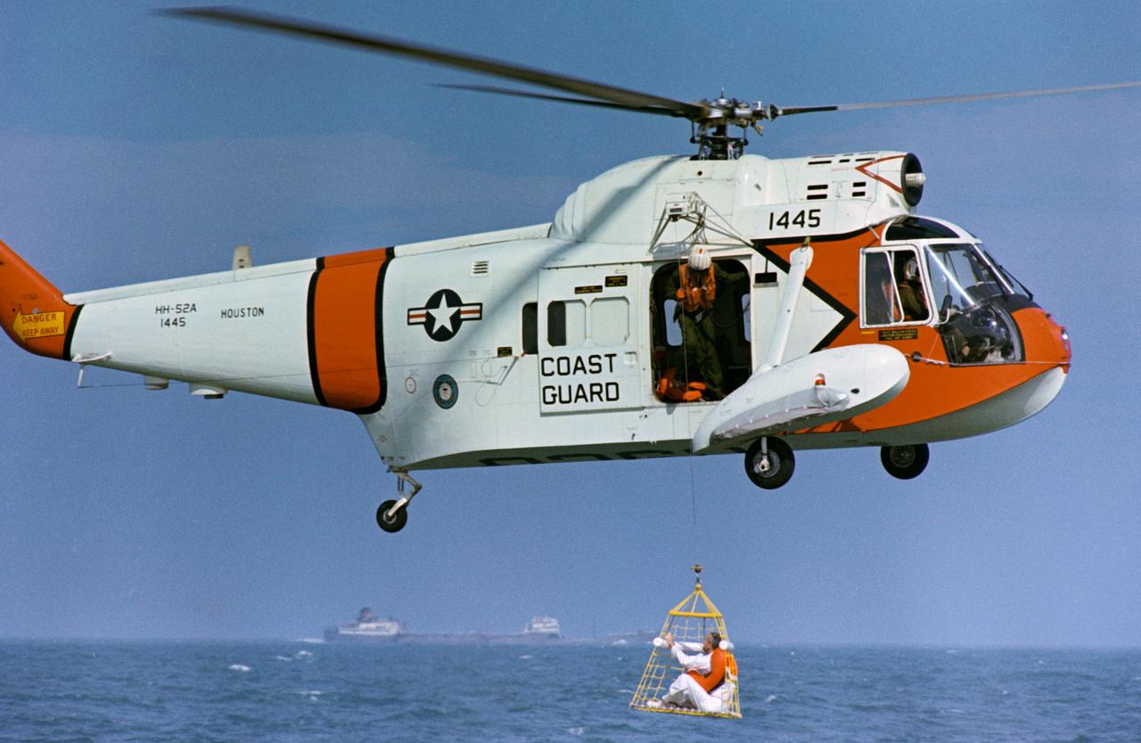 S68-50989 (20 Nov. 1968) --- Astronaut James A. McDivitt, commander of the Apollo 9 prime crew, is hoisted up to a U.S. Coast Guard helicopter in a new type rescue net during water egress training in the Gulf of Mexico.