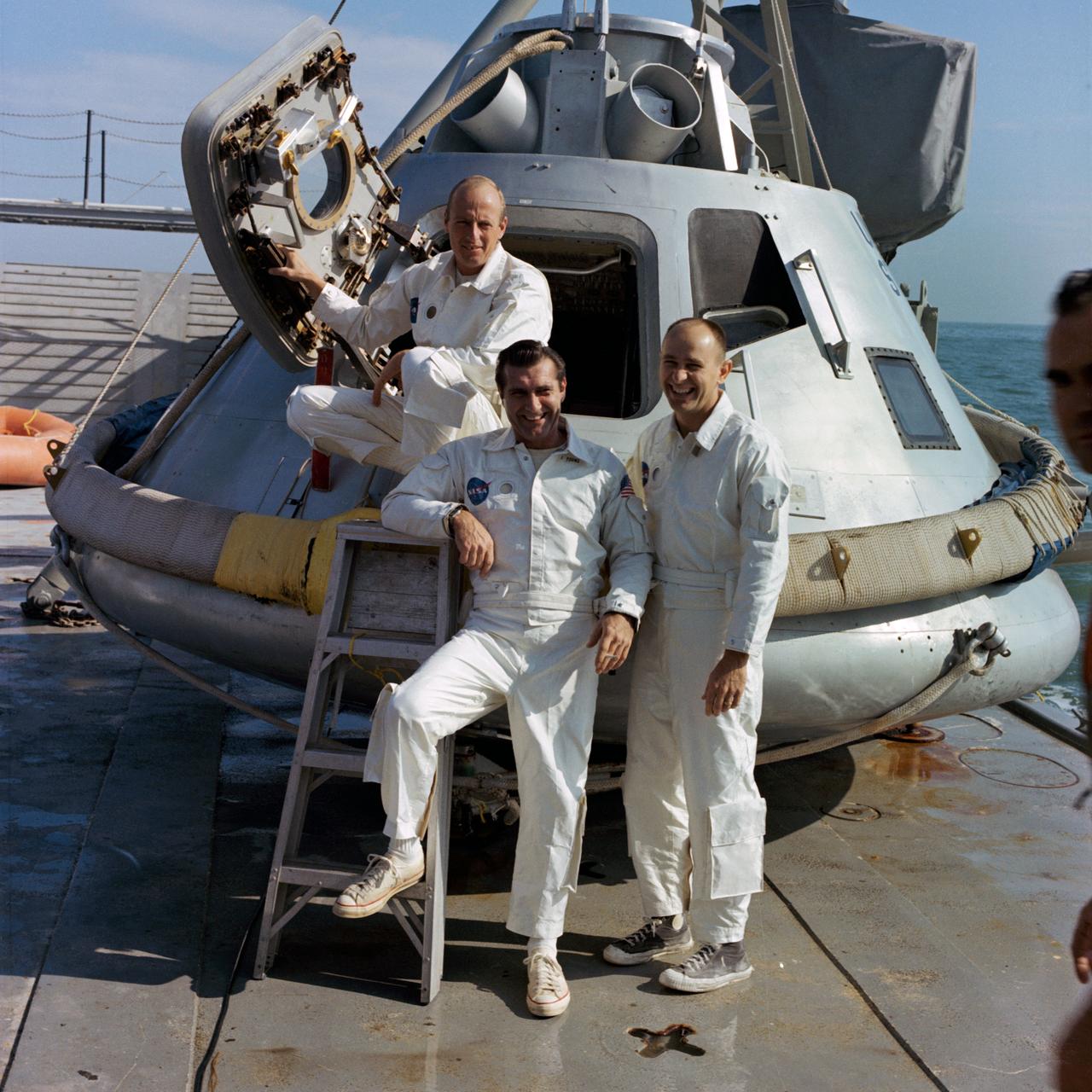 S68-51700 (November 1968) --- The backup crew of the Apollo 9 (Spacecraft 104/ Lunar Module 3/ Saturn 504) space mission stands on the deck of the NASA Motor Vessel Retriever (MVR) prior to participating in water egress training in the Gulf of Mexico. Left to right, are astronauts Charles Conrad Jr. (holding hatch), Richard F. Gordon Jr., and Alan L. Bean. They are standing by the Apollo command module trainer which was used in the exercise. Since this photograph was made, these three astronauts have been named as the prime crew of the Apollo 12 lunar landing mission.