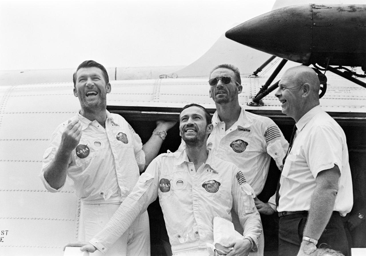 S68-52542 (22 Oct. 1968) --- The Apollo 7 crew arrives aboard the USS Essex, the prime recovery ship for the mission. Left to right, are astronauts Walter M. Schirra Jr., commander; Donn F. Eisele, command module pilot; Walter Cunningham, lunar module pilot; and Dr. Donald E. Stullken, NASA Recovery Team Leader from the Manned Spacecraft Center's (MSC) Landing and Recovery Division. The crew is pausing in the doorway of the recovery helicopter.