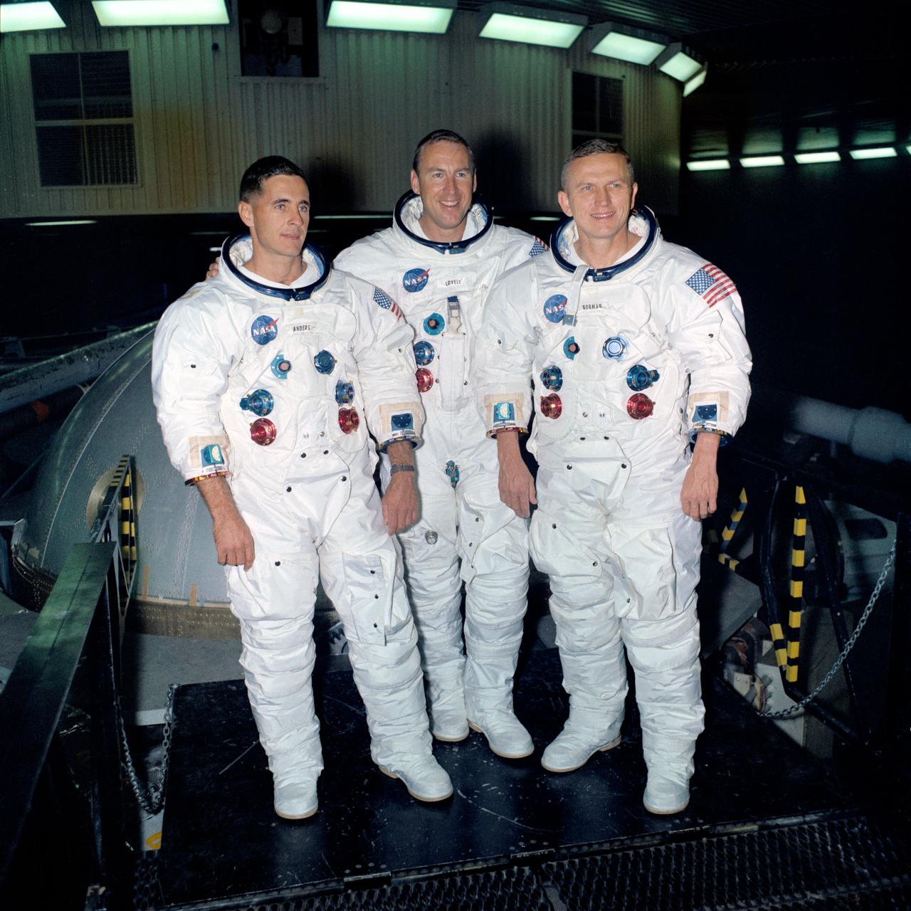 S68-53187 (1 Nov. 1968) --- The prime crew of the Apollo 8 lunar orbit mission stands beside the gondola in Building 29 after suiting up for centrifuge training in the Manned Spacecraft Center's (MSC) Flight Acceleration Facility (FAF). Left to right, are astronauts William A. Anders, lunar module pilot; James A. Lovell Jr., command module pilot; and Frank Borman, commander.