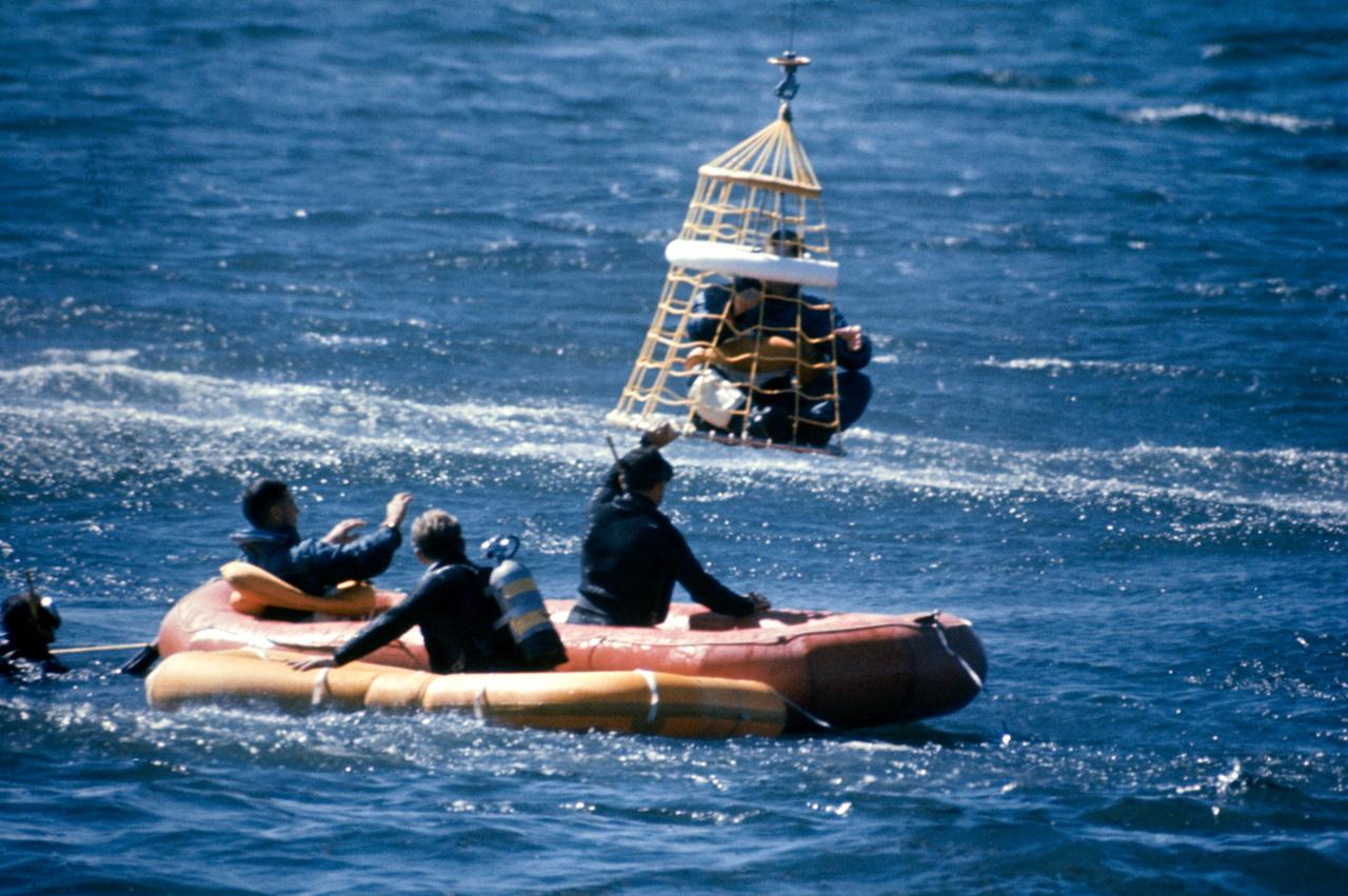 S68-53217 (19 Oct. 1968) --- Astronaut James A. Lovell Jr., command module pilot of the Apollo 8 prime crew, in special net being hoisted up to a U.S. Coast Guard helicopter during water egress training in the Gulf of Mexico. Awaiting his turn for helicopter pickup is astronaut William A. Anders (in raft), lunar module pilot. Astronaut Frank Borman, commander, had already been picked up. A team of Manned Spacecraft Center (MSC) swimmers assisted with the training exercise.
