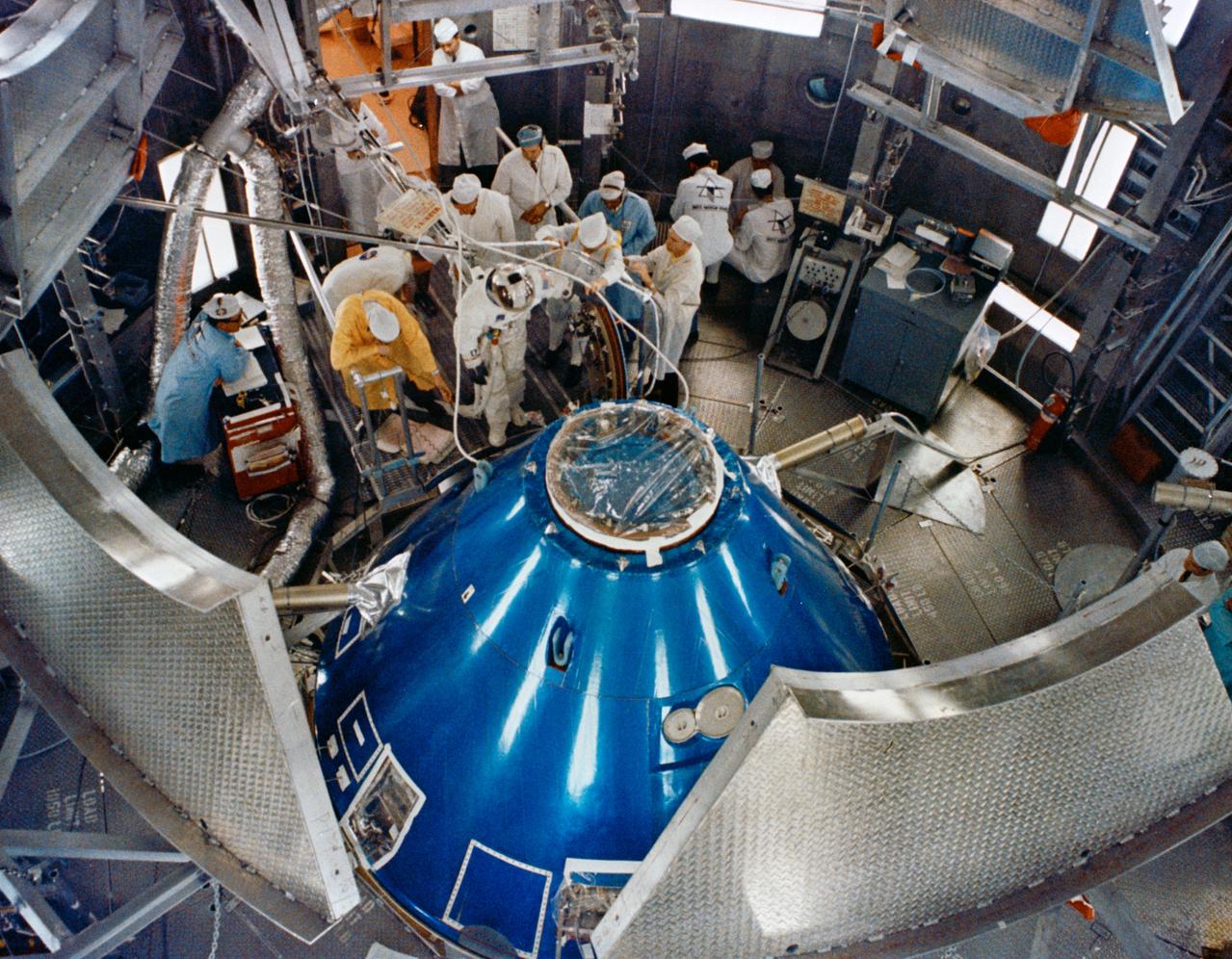 S68-55255 (6 Nov. 1968) --- Overhead view of Altitude Chamber "L" in the Kennedy Space Center's Manned Spacecraft Operations Building showing a member of the Apollo 9 backup crew preparing to ingress the Apollo 9 spacecraft for egress test and simulated altitude run. The Apollo 9 backup crew consists of astronauts Charles Conrad Jr., Richard F. Gordon Jr., and Alan L. Bean.