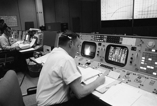 NASA image: Clifford Charlesworth seated at his console in Mission Control Room