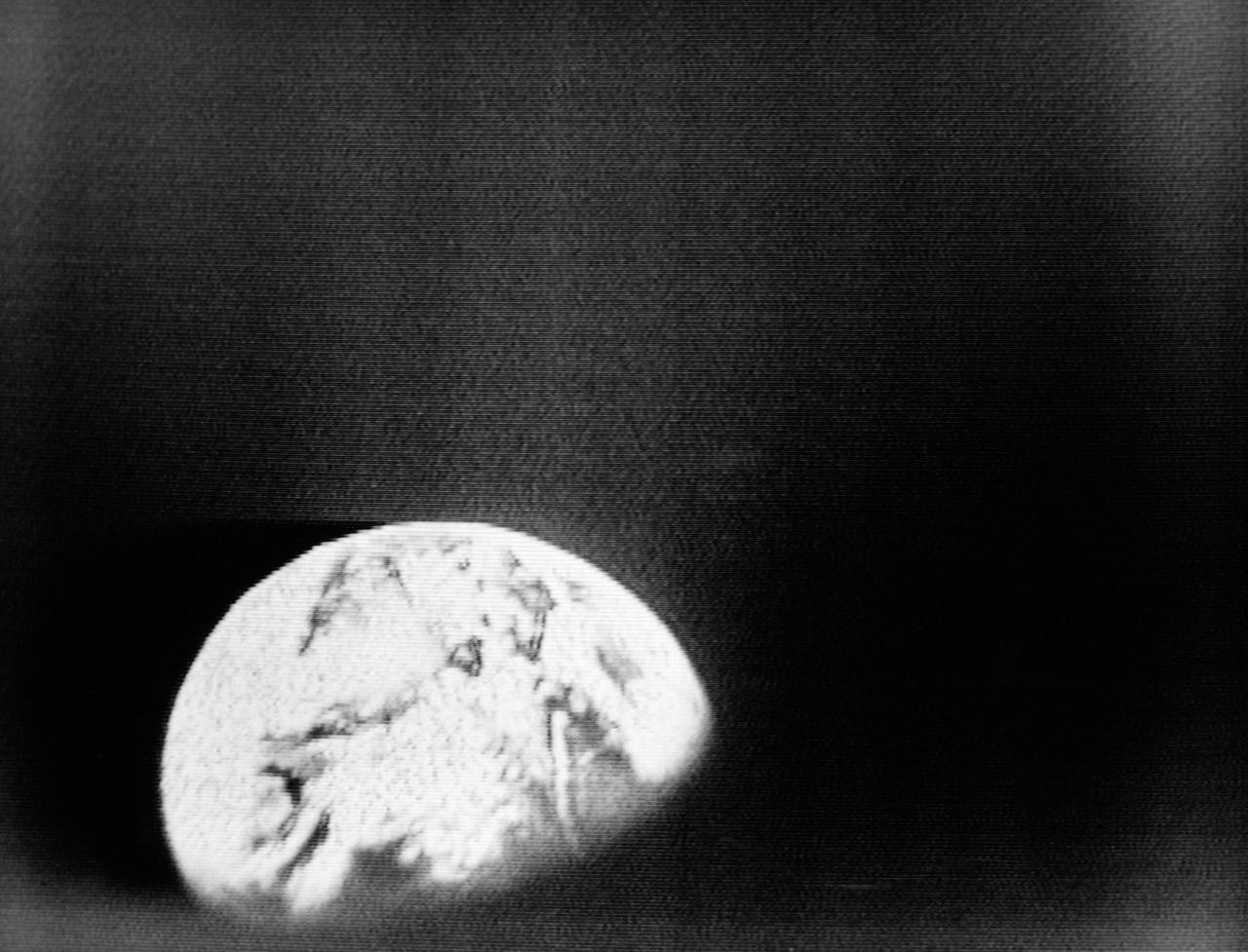 S68-55808 (23 Dec. 1968) --- This spectacular view of Earth was transmitted back from space during the second live television transmission from the Apollo 8 spacecraft on the third day of its journey toward the moon. This view is looking through a spacecraft window. At the time of this TV transmission (at 2 p.m. CST), Apollo 8 was traveling on its trans-lunar course at about 3,254 feet per second, and was some 176,533 miles from Earth.