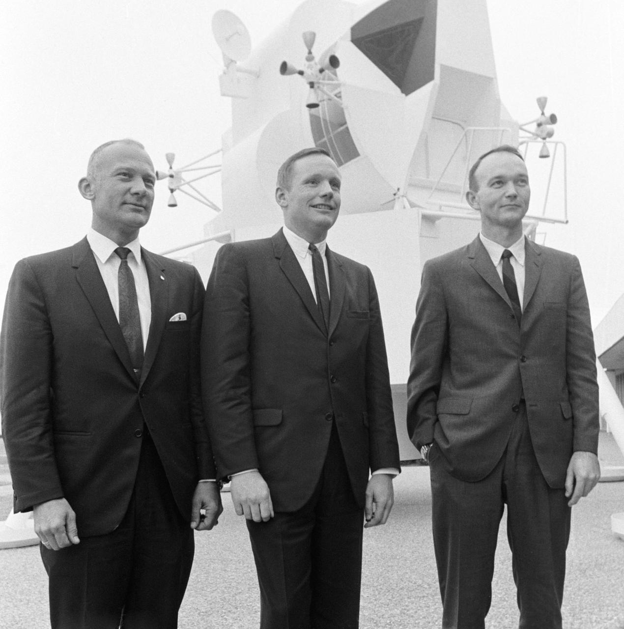 S69-16682 (10 Jan. 1969) --- These three astronauts have been selected by NASA as the prime crew of the Apollo 11 lunar landing mission. Left to right, are Edwin E. Aldrin Jr., lunar module pilot; Neil A. Armstrong, commander; and Michael Collins, command module pilot. They are photographed in front of a lunar module mock-up beside Building 1 following a press conference in the MSC Auditorium.