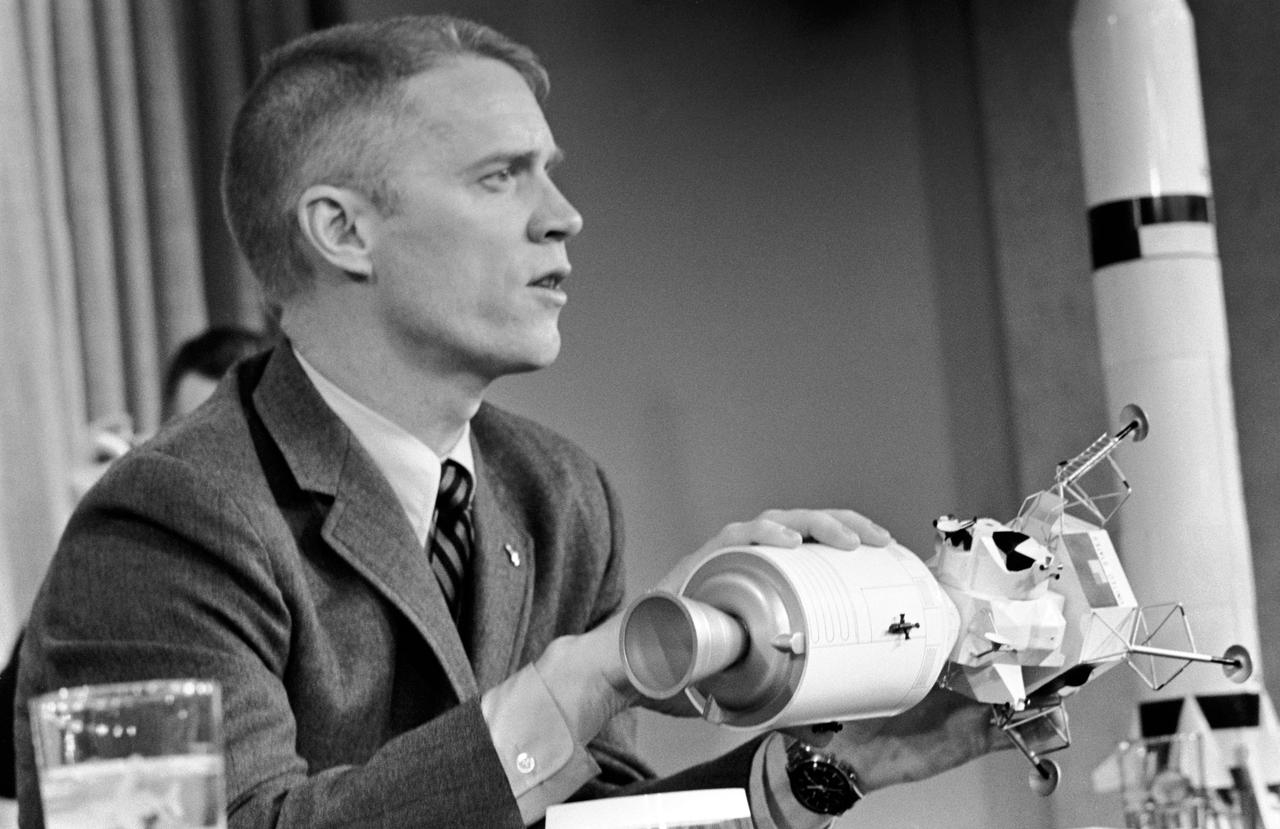 S69-17615 (25 Jan. 1969) --- Astronaut Russell L. Schweickart, lunar module pilot of the Apollo 9 prime crew, participates in a press conference at the Grumman Aircraft Engineering Corporation. Grumman is the contractor to NASA for the Lunar Module. Schweickart is holding a model of a docked Lunar Module/Command and Service Modules. The Apollo 9 mission will evaluate spacecraft lunar module systems performance during manned Earth-orbital flight.