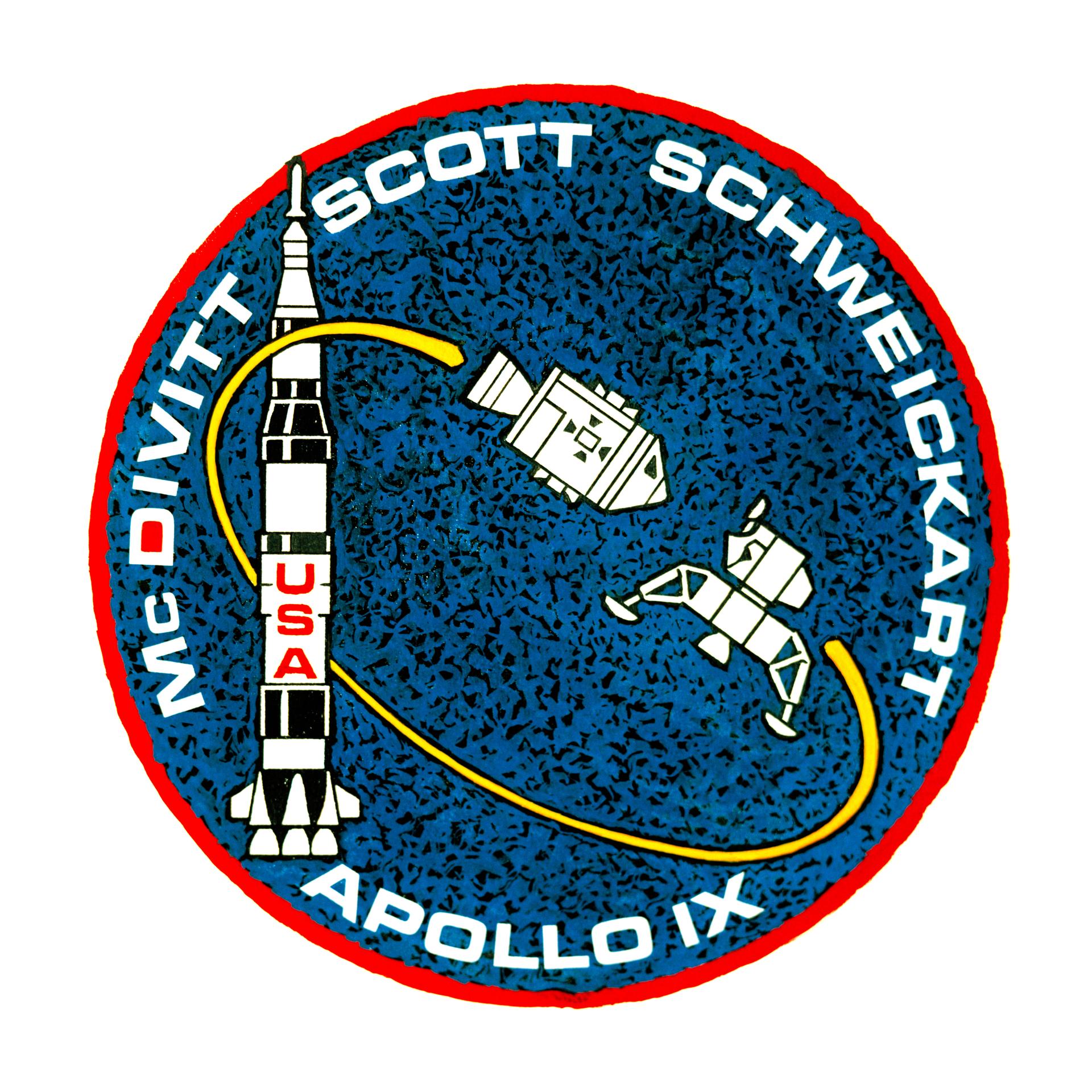 Apollo 9 mission patch with images of the Saturn V rocket, the command and service module, and the lunar module. Around the edge, the words Apollo IX, McDivitt, Scott, and Schweickart are seen.