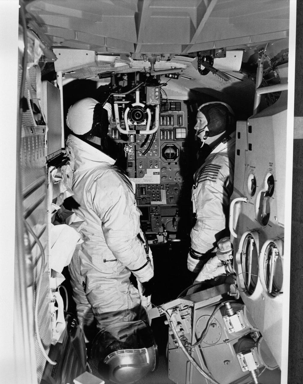 S69-19858 (December 1968) --- Two members of the Apollo 9 prime crew participate in simulation training in the Apollo Lunar Module Mission Simulator (LMMS) at the Kennedy Space Center (KSC). On the left is astronaut James A. McDivitt, commander; and on the right is astronaut Russell L. Schweickart, lunar module pilot.