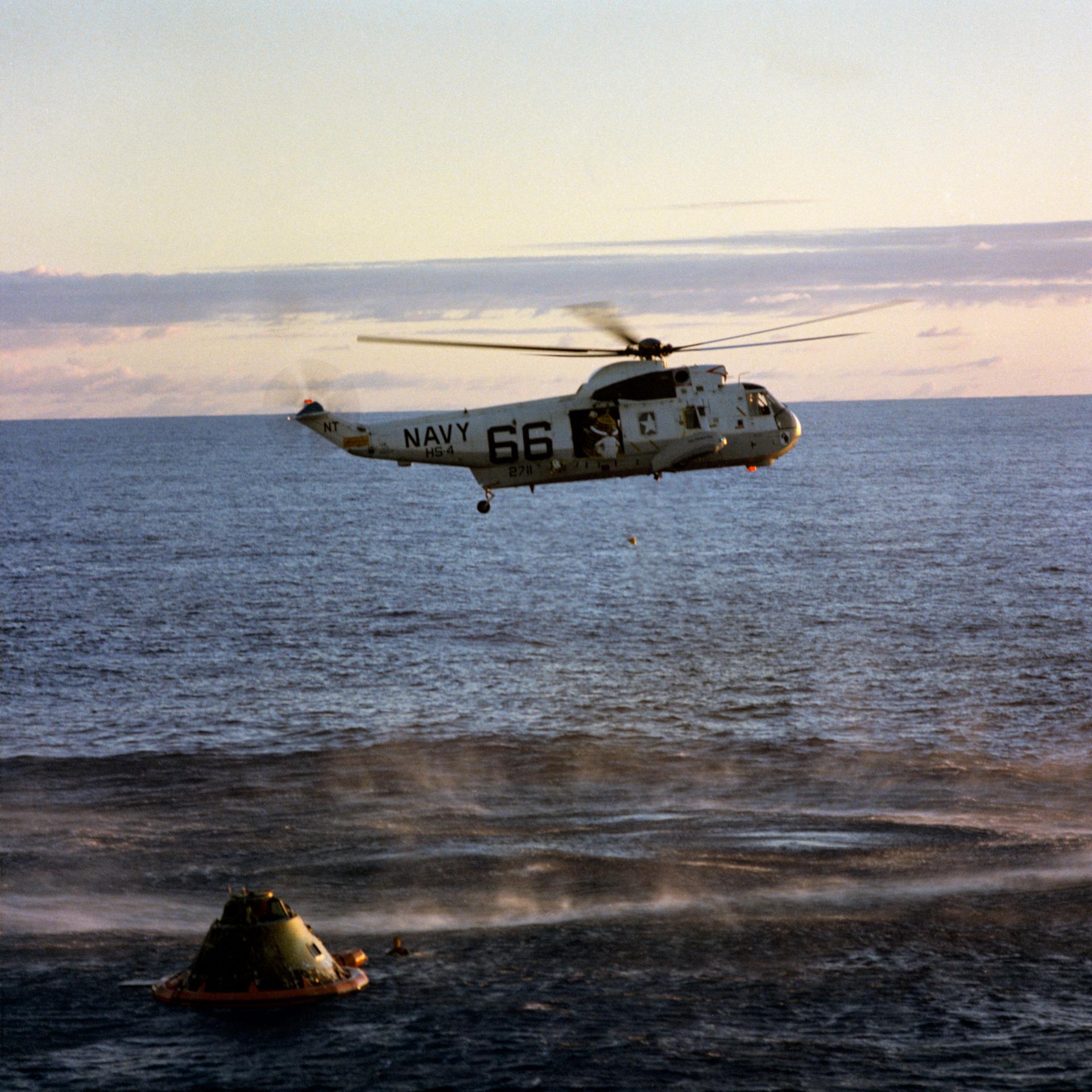Helicopter hovering over the Apollo 10 capsule floating in the South Pacific