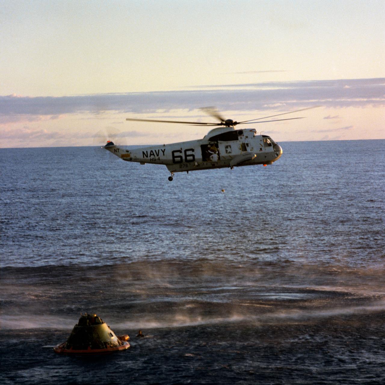 S69-20621 (26 May 1969) --- A member of the Apollo 10 crew is hoisted into a helicopter from the prime recovery ship, USS Princeton, during recovery operations in the South Pacific. Astronauts Thomas P. Stafford, commander; John W. Young, command module pilot; and Eugene A. Cernan, lunar module pilot, were picked up and flown to the deck of the USS Princeton where a red-carpet welcome awaited them. The spacecraft was later retrieved from the water and put aboard the recovery ship. The Apollo 10 splashdown occurred at 11:53 a.m. (CDT), May 26, 1969, about 400 miles east of American Samoa, and about four miles from the recovery ship, to conclude a successful eight-day lunar orbit mission. U.S. Navy underwater demolition team swimmers assisted in the recovery operations.