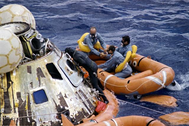 NASA image: Apollo 12 crew assisted with egressing command module after landing