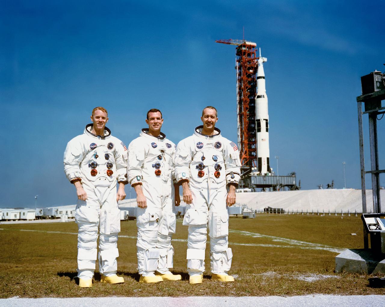 S69-25478 (23 Feb. 1969) --- These three astronauts are the prime crew of the Apollo 9 Earth-orbital space mission. Left to right, are Russell L. Schweickart, lunar module pilot; David R. Scott, command module pilot; and James A. McDivitt, commander. In the right background is the Apollo 9 space vehicle on Pad A, Launch Complex 39, Kennedy Space Center (KSC). They are pausing momentarily during training for their scheduled 10-day mission.