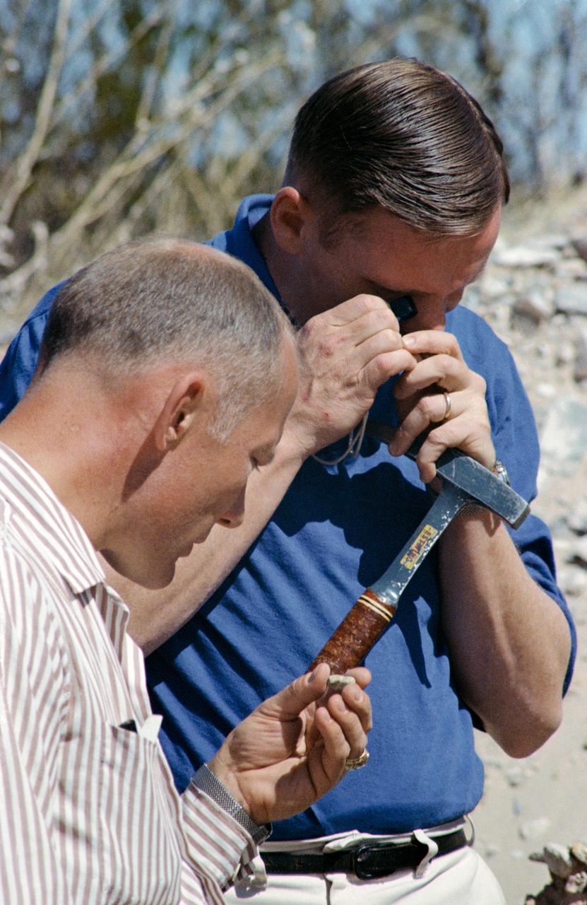 S69-25944 (25 Feb. 1969) --- These two Apollo 11 crew astronauts study rock samples during a geological field trip to the Quitman Mountains area near the Fort Quitman ruins in far west Texas. Neil A. Armstrong (in background) is the Apollo 11 commander; and Edwin E. Aldrin Jr. is the lunar module pilot.