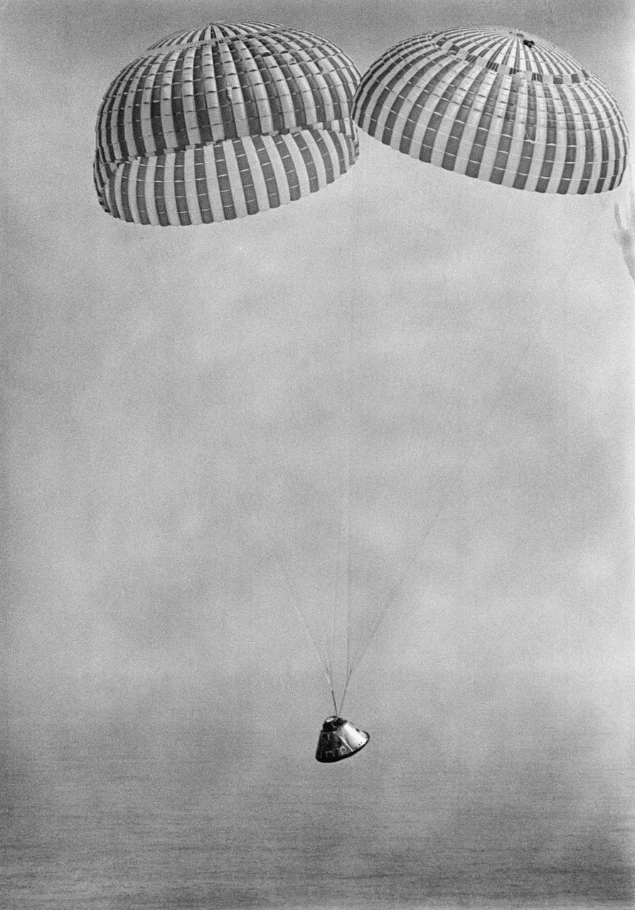 S69-27467 (13 March 1969) --- The Apollo 9 spacecraft, with astronauts James A. McDivitt, David R. Scott, and Russell L. Schweickart aboard, approaches touchdown in the Atlantic recovery area. Splashdown occurred at 12:00:53 p.m. (EST), March 13, 1969, only 4.5 nautical miles from the prime recovery ship, USS Guadalcanal. Photo credit: NASA