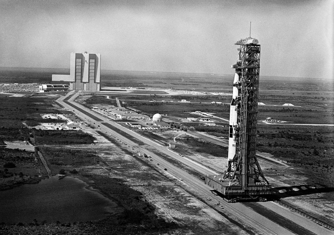 S69-27741 (11 March 1969) --- Aerial view at Launch Complex 39, Kennedy Space Center, showing the 363-feet tall Apollo 10 (Spacecraft 106/Lunar Module-4/Saturn 505) space vehicle on its way to Pad B. The Vehicle Assembly Building is in the background. The Saturn V stack and its mobile launch tower are atop a huge crawler-transporter. The Apollo 10 flight is schedule as a lunar orbit mission. The Apollo 10 crew will be astronauts Thomas P. Stafford, commander; John W. Young, command module pilot; and Eugene A. Cernan, lunar module pilot.