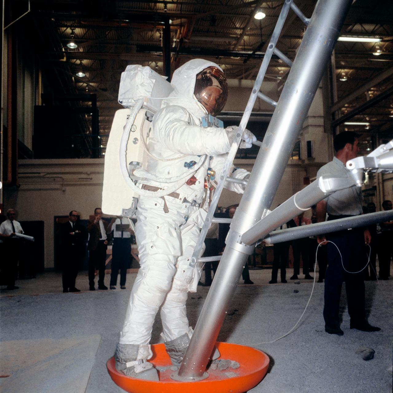 S69-31042 (18 April 1969) --- Suited astronaut Neil A. Armstrong, wearing an Extravehicular Mobility Unit (EMU), participates in lunar surface simulation training on April 18, 1969, in Building 9, Manned Spacecraft Center (MSC).  Armstrong is the prime crew commander of the Apollo 11 lunar landing mission.  Here, he is standing on Lunar Module (LM) mockup foot pad preparing to ascend steps.