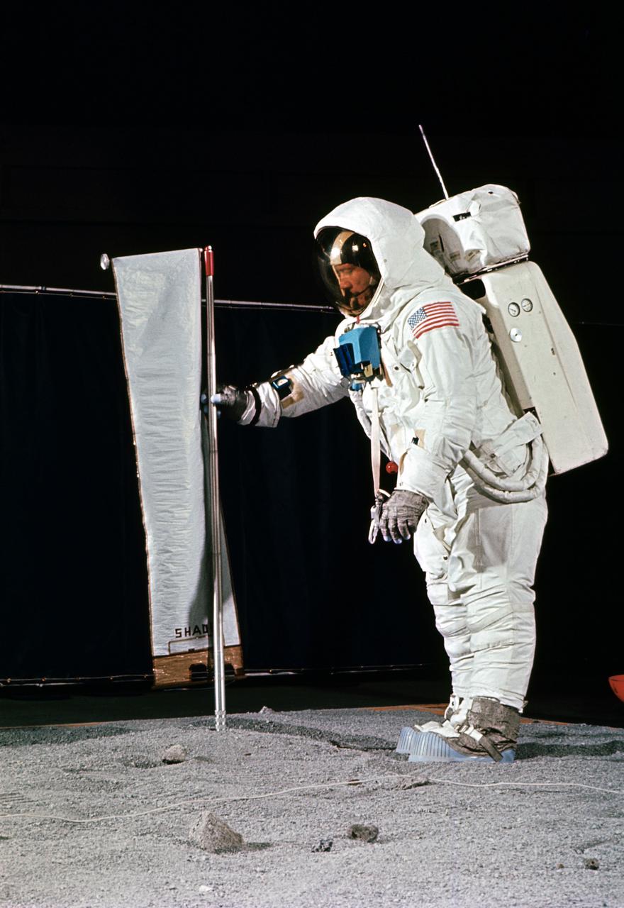 S69-32247 (22 April 1969) --- Astronaut Edwin E. Aldrin Jr., wearing an Extravehicular Mobility Unit (EMU), simulates deploying the Solar Wind Composition (SWC) experiment, on the surface of the moon, during a training exercise in Building 9 on April 22, 1969.  The SWC is a component of the Early Apollo Scientific Experiment Package (EASEP). Aldrin is the lunar module pilot of the Apollo 11 lunar landing mission.