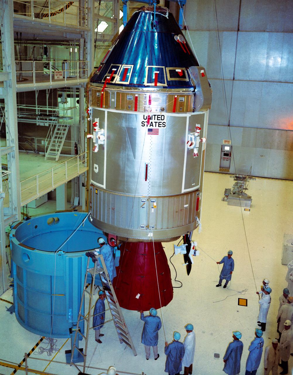 S69-32370 (11 April 1969) --- Interior view of the Kennedy Space Center's (KSC) Manned Spacecraft Operations Building showing Apollo Spacecraft 107 Command and Service Modules (CSM) being moved from work stand 134 for mating to Spacecraft Lunar Module Adapter (SLA) 14.  S/C 107 is scheduled to be flown on the Apollo 11 lunar landing mission.
