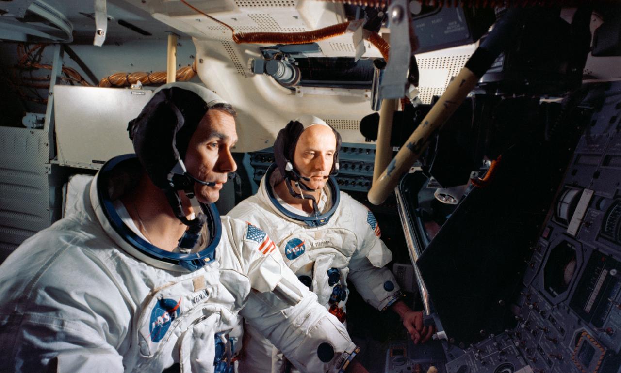 S69-32615 (April 1969) --- Two members of the Apollo 10 prime crew participate in simulation activity at the Kennedy Space Center during preparations for their scheduled lunar orbit mission. Astronaut Thomas P. Stafford, commander, is in the background; and in the foreground is astronaut Eugene A. Cernan, lunar module pilot. The two crewmen are in the Lunar Module Mission Simulator.