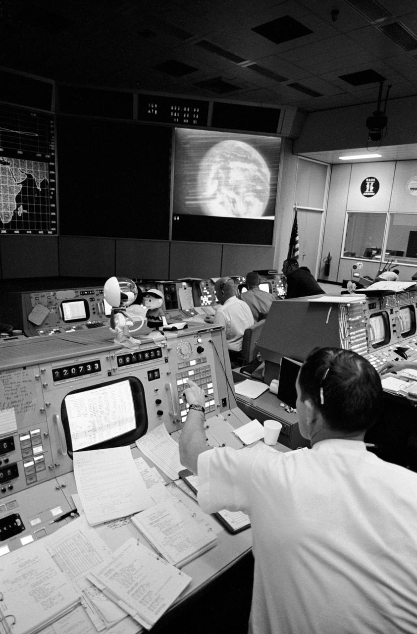 S69-34040 (18 May 1969) --- Partial view of activity in the Mission Operations Control Room in the Mission Control Center, Building 30, on the first day of the Apollo 10 lunar orbit mission. The television monitor shows a picture of Earth made during the second telecast from the Apollo 10's color TV camera.